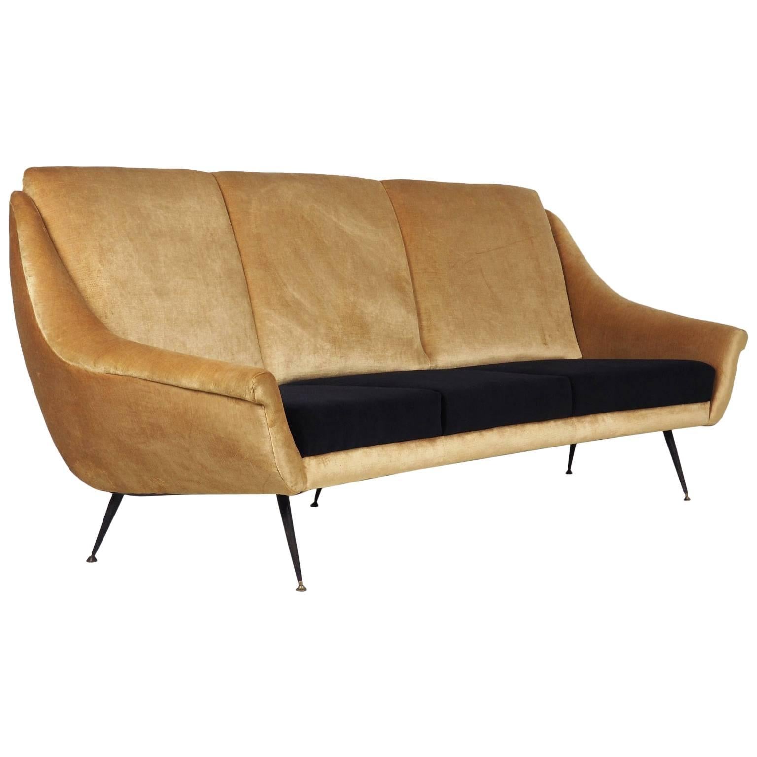 Elegant three seats curved sofa designed by Federico Munari in 1950. New upholstery with black and gold velvet. 
Black lacquered metal legs with brass feet.
 