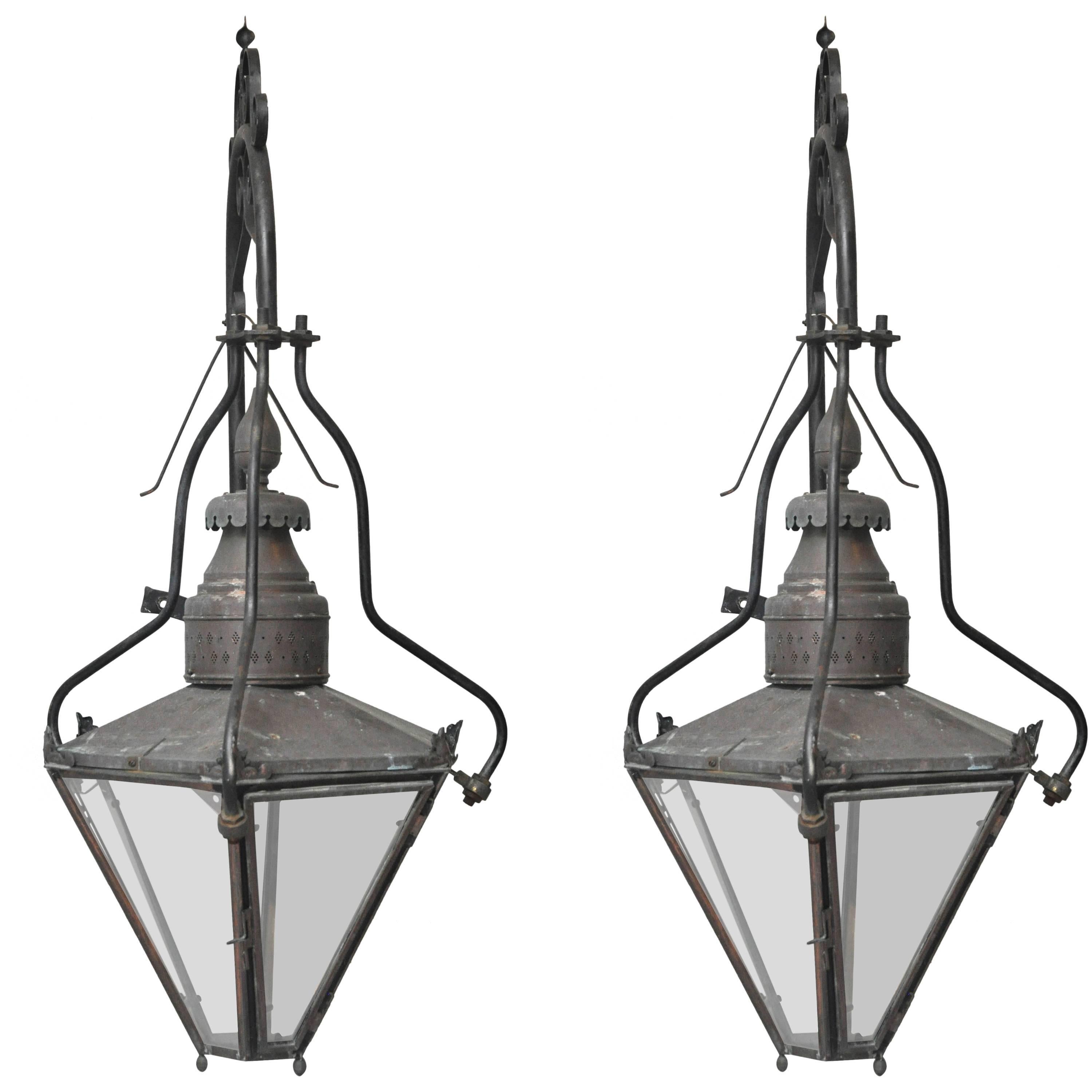 Pair of one of a kind Monumental English Outdoor Wall Light Sconces, originally gas converted to electric. Lantern comprised of six glass shades, patinated copper bonnet surmounted with copper circular reticulated vent,  three shapely painted black