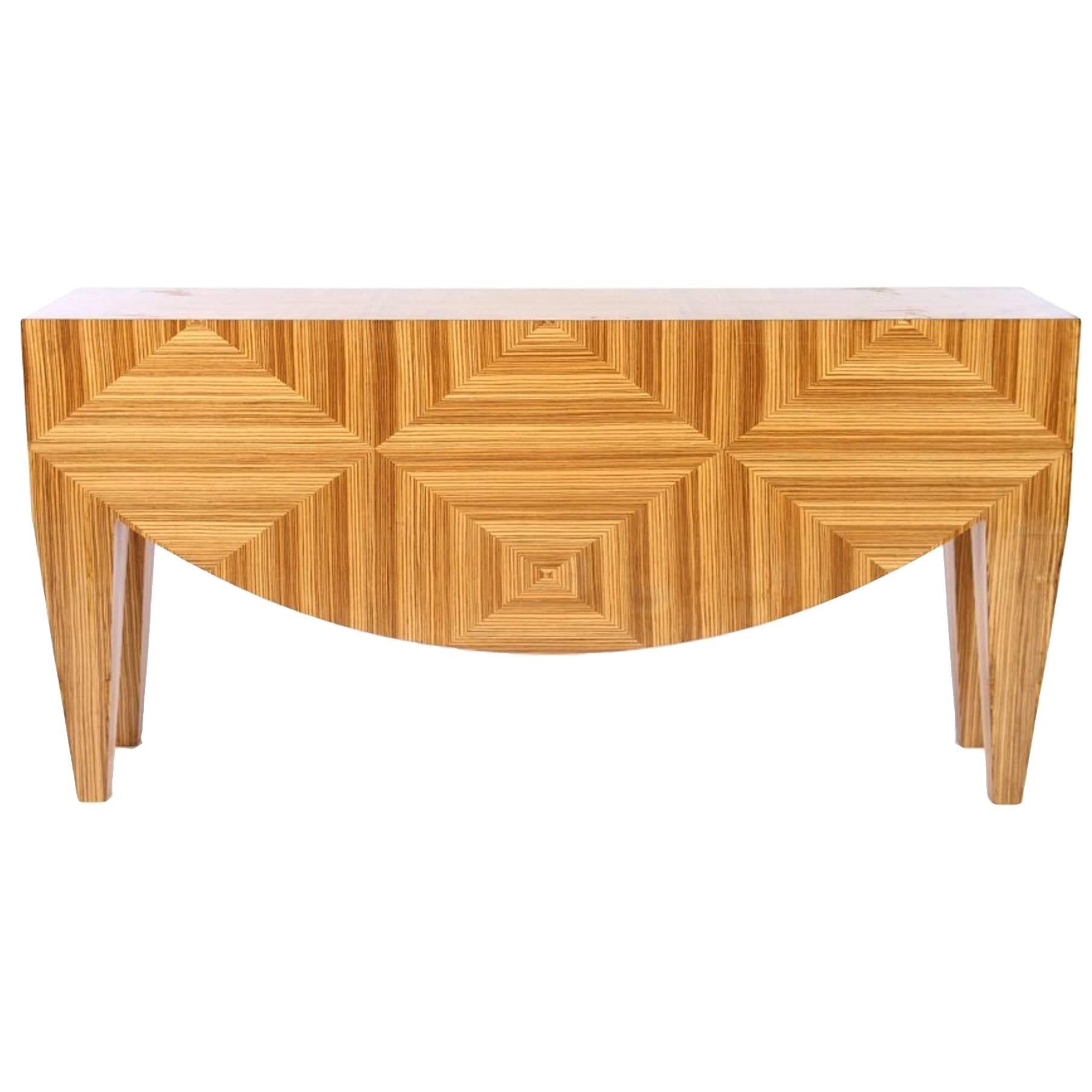 Post-Modern figured wood parquetry design console table; Exotic wood demilune apron front and tapered legs. 

Dimensions: 36