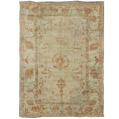 Antique Oushak Rug with Pastel Colors in Tan, Ivory, Light Green and Soft Orange