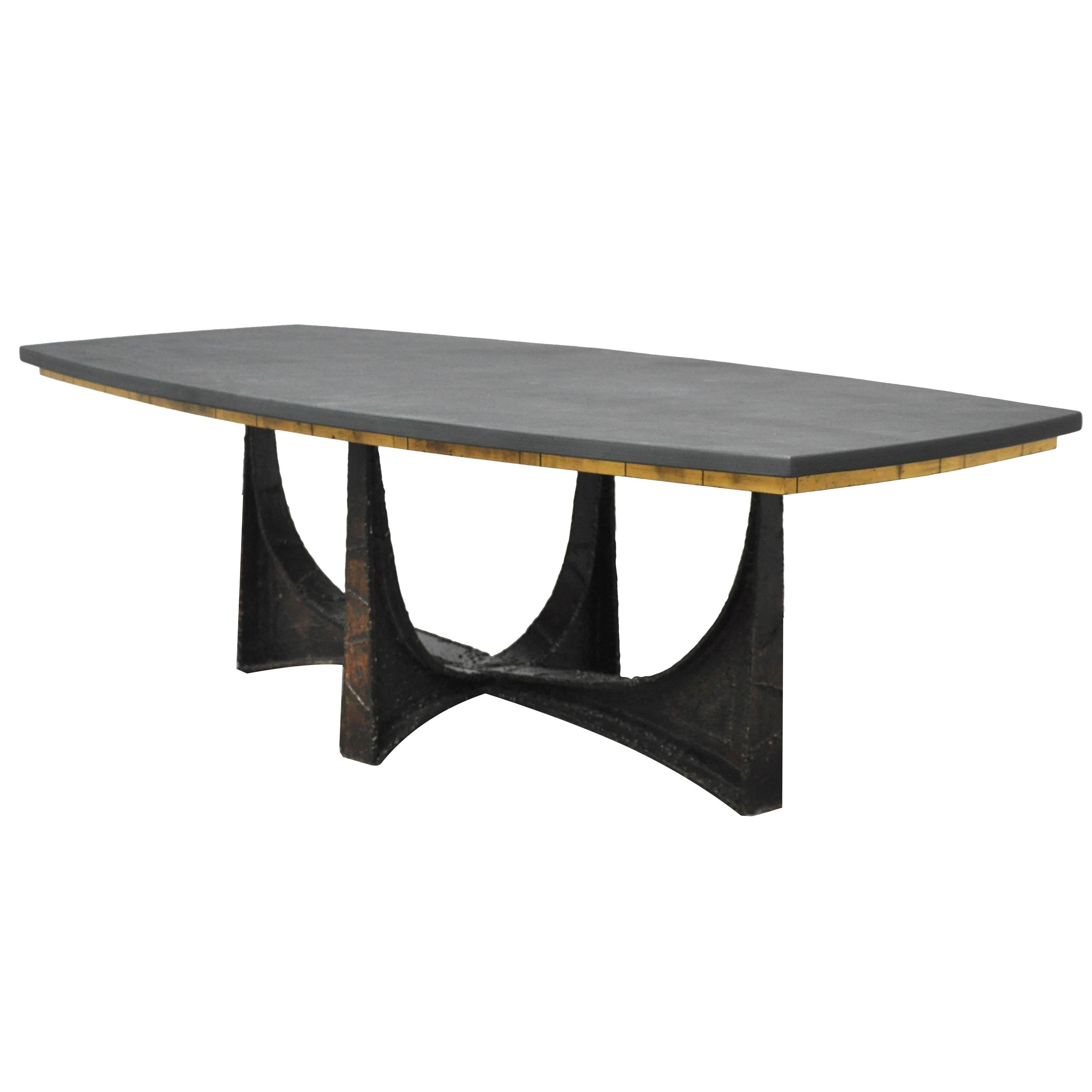 Rare and early coffee table by Paul Evans. Sculpture base of made of forged steel. Slate top with gold leaf apron. Welded signature to underside of base: 