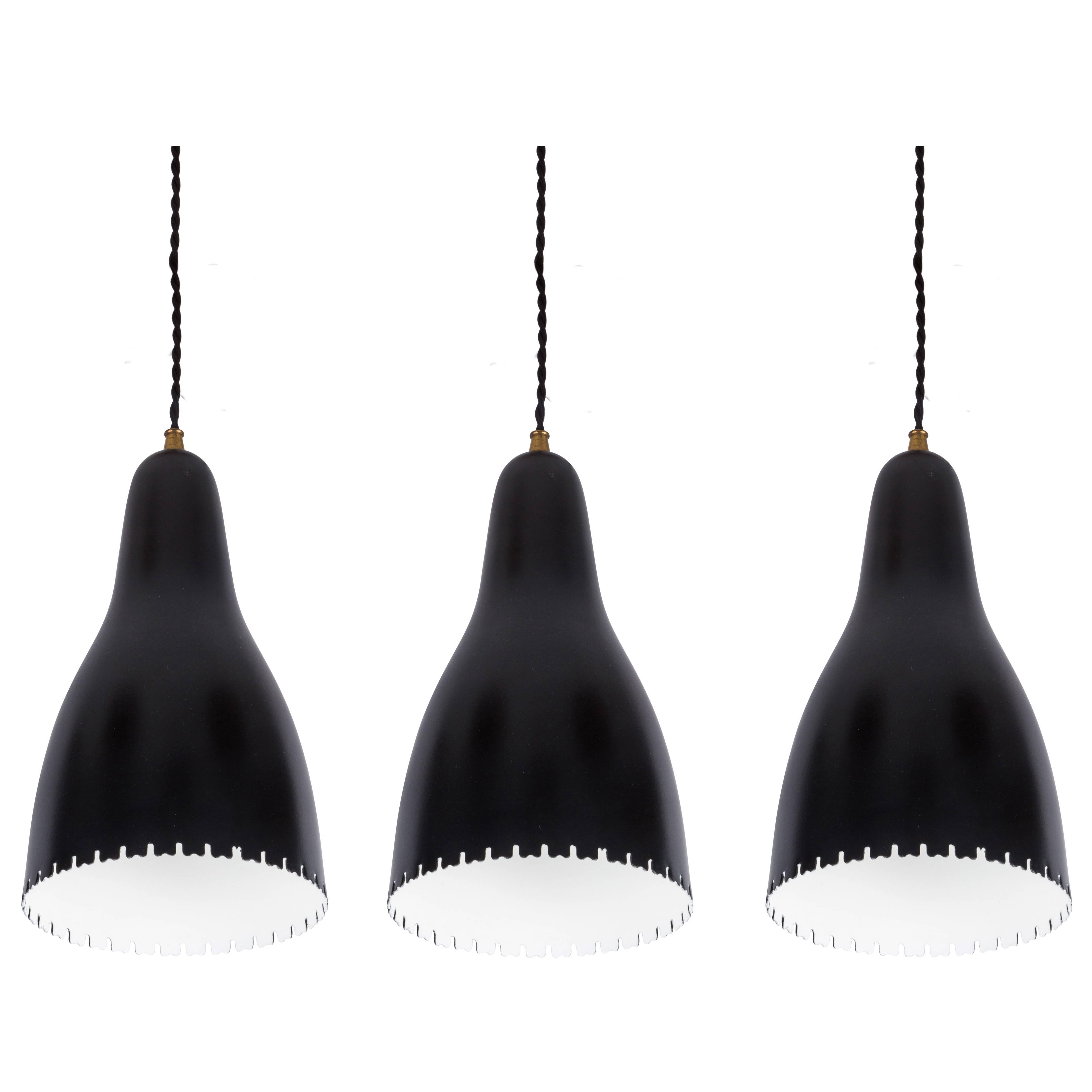 1950s Bent Karlby Pendants for Lyfa. Executed in architecturally cut and elegantly shaped black painted metal and brass, Denmark, circa 1950s.

Price is for set of 3.

Not UL listed, but available from authorized 3rd party vendor upon request