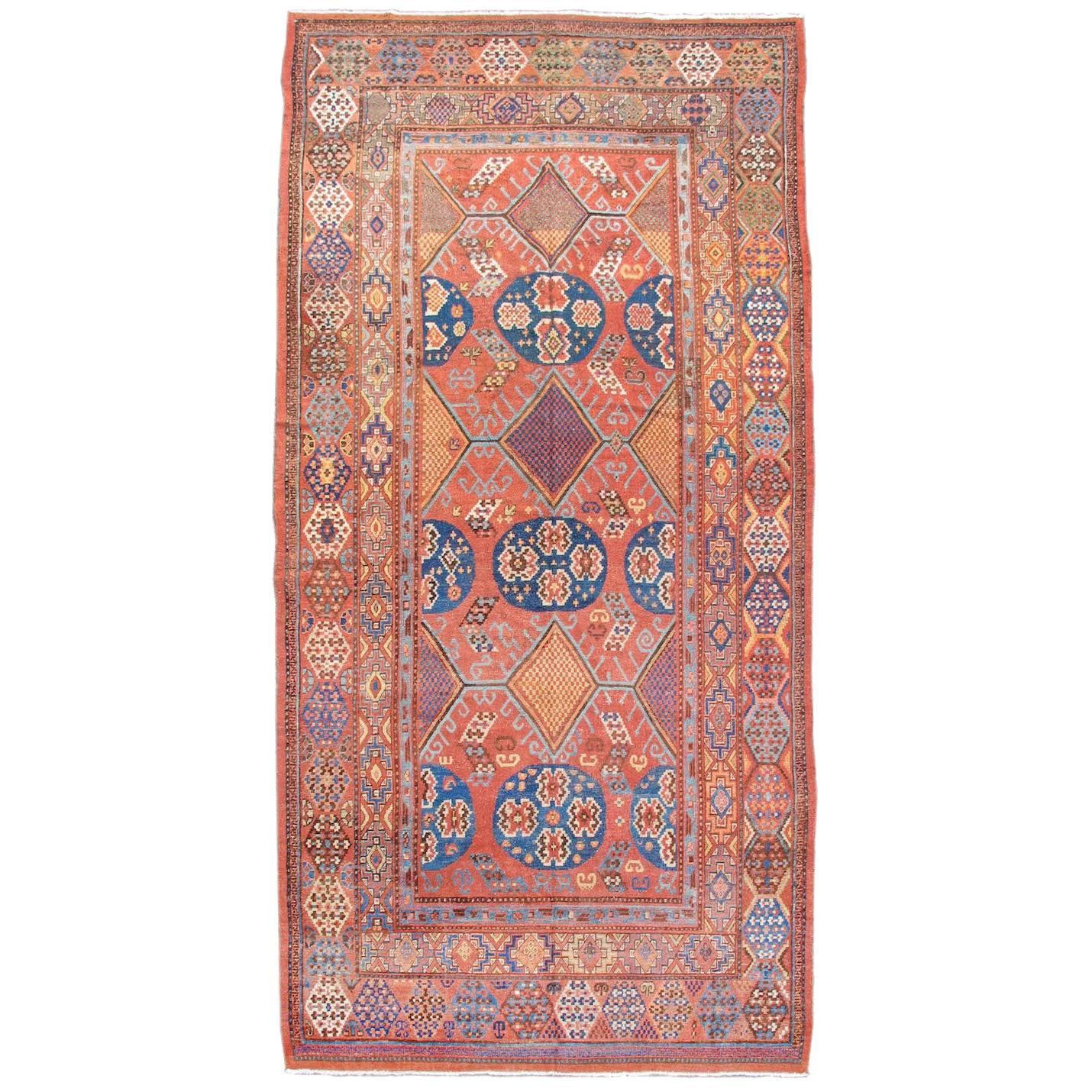 Early 19th Century Red and Blue Khotan Carpet