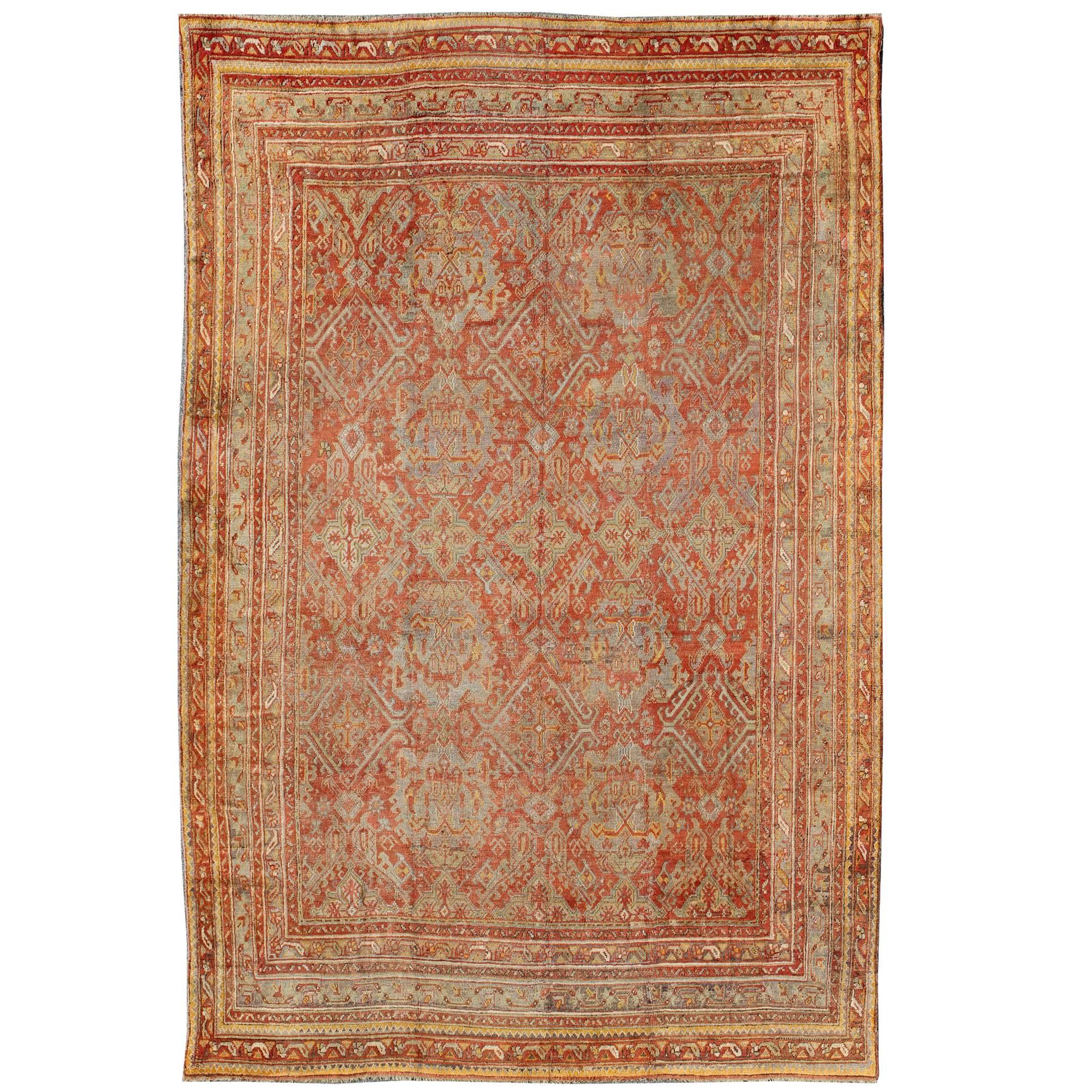 Antique Turkish Oushak Rug with Geometric Design in Soft Red, Light Blue, Yellow For Sale