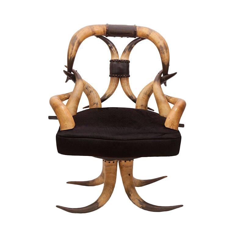 19th Century Steer Horn Chair Upholstered in Ralph Lauren Black Velvet

Chair dimensions: 37'' H x 28'' W x 23'' D.
Ottoman dimensions: 20'' L x 10.5'' H x 11'' W