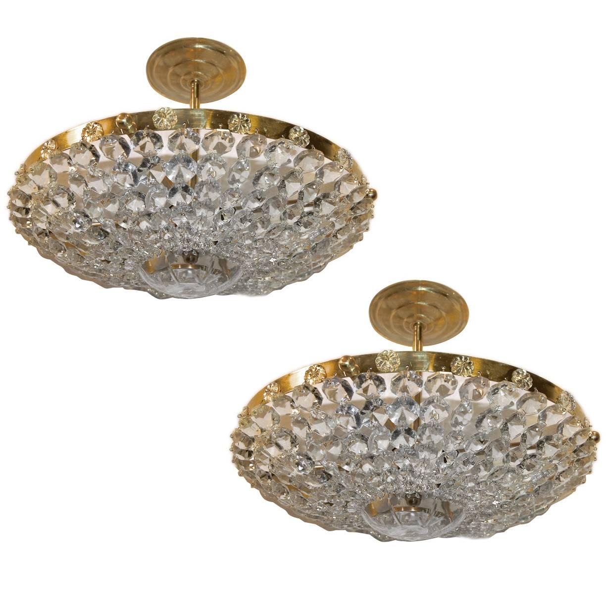 Set of 12 circa 1940's French crystal pendant light fixtures with three interior lights and crystal rosettes on body. Sold individually.

Measurements:
Drop: 7.5