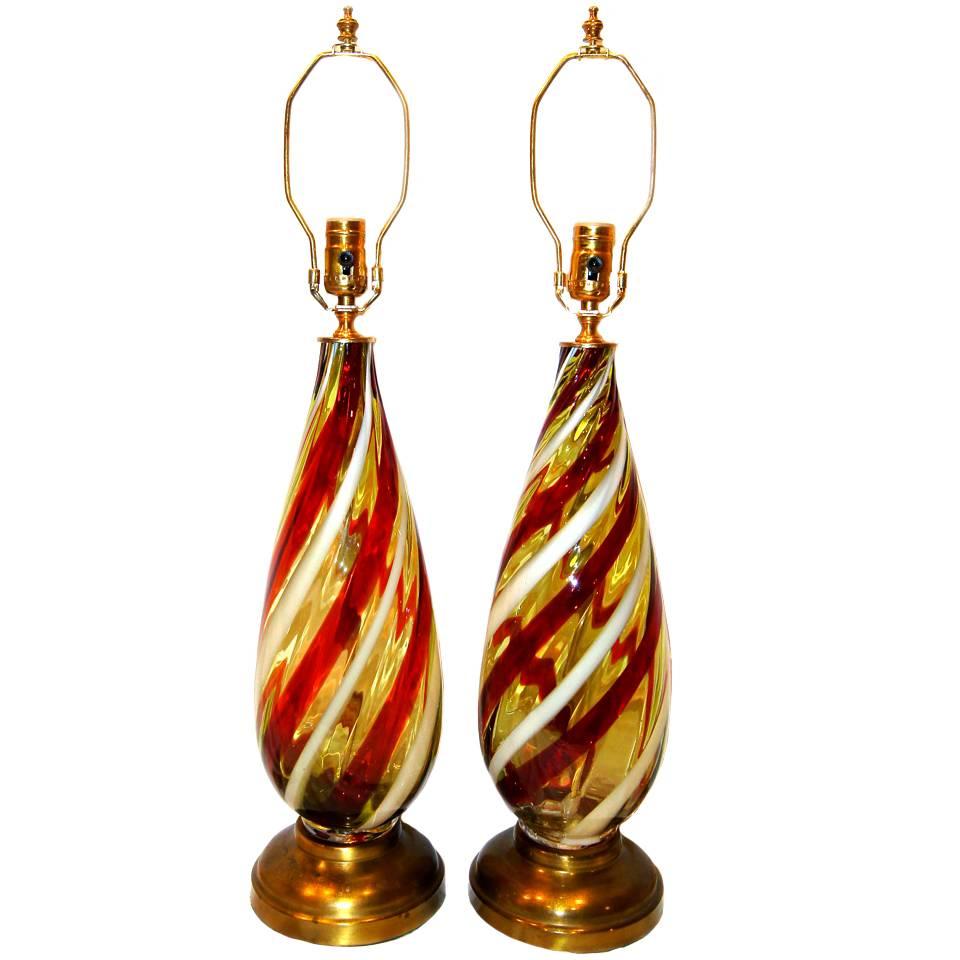 A pair of circa 1950s Murano red and white ribbon glass table lamps.
 
Measurements:
Height of body: 19.5