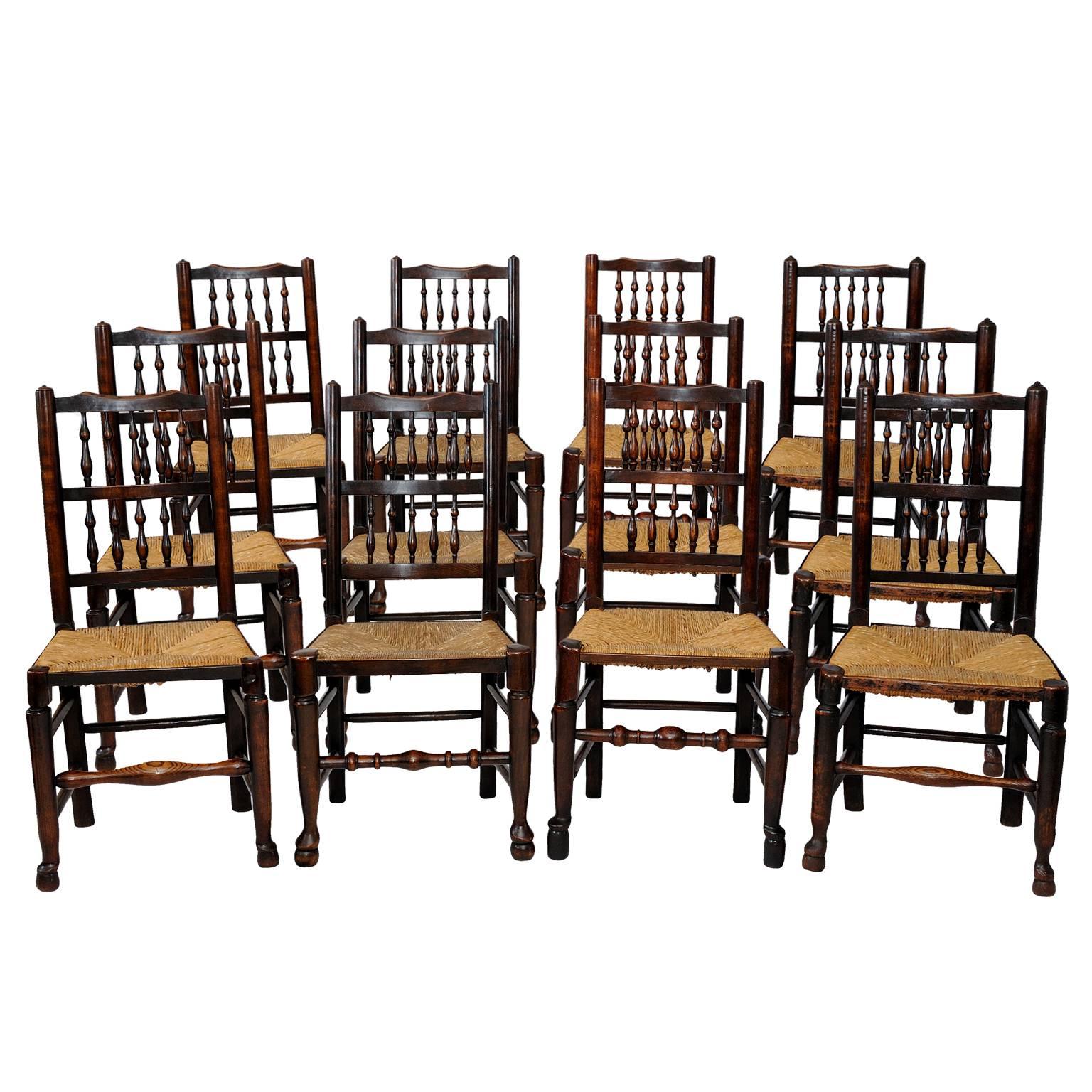 A Harlequin set of 12 Georgian Oak and Elm Spindle Back Chairs, circa 1820 For Sale