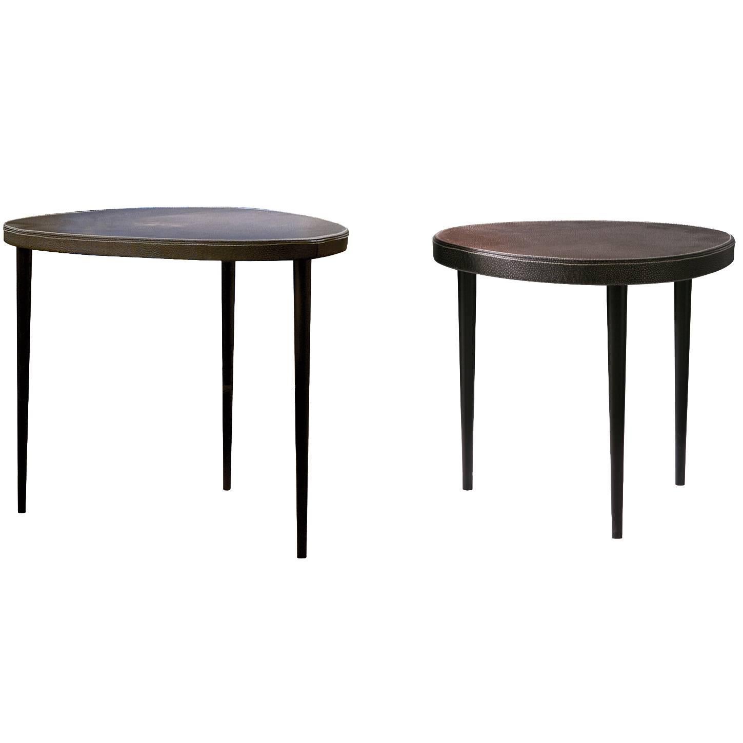 Pair of nesting modern versatile leather top side tables. Design: Kaki Kroener.

Moon table-choice of:
Top: Black or ivory galuchat finishing leather. Legs: Mat black lacquered
cm.43 x 45 H.
Top: Ivory galuchat finishing leather. Legs: Mat