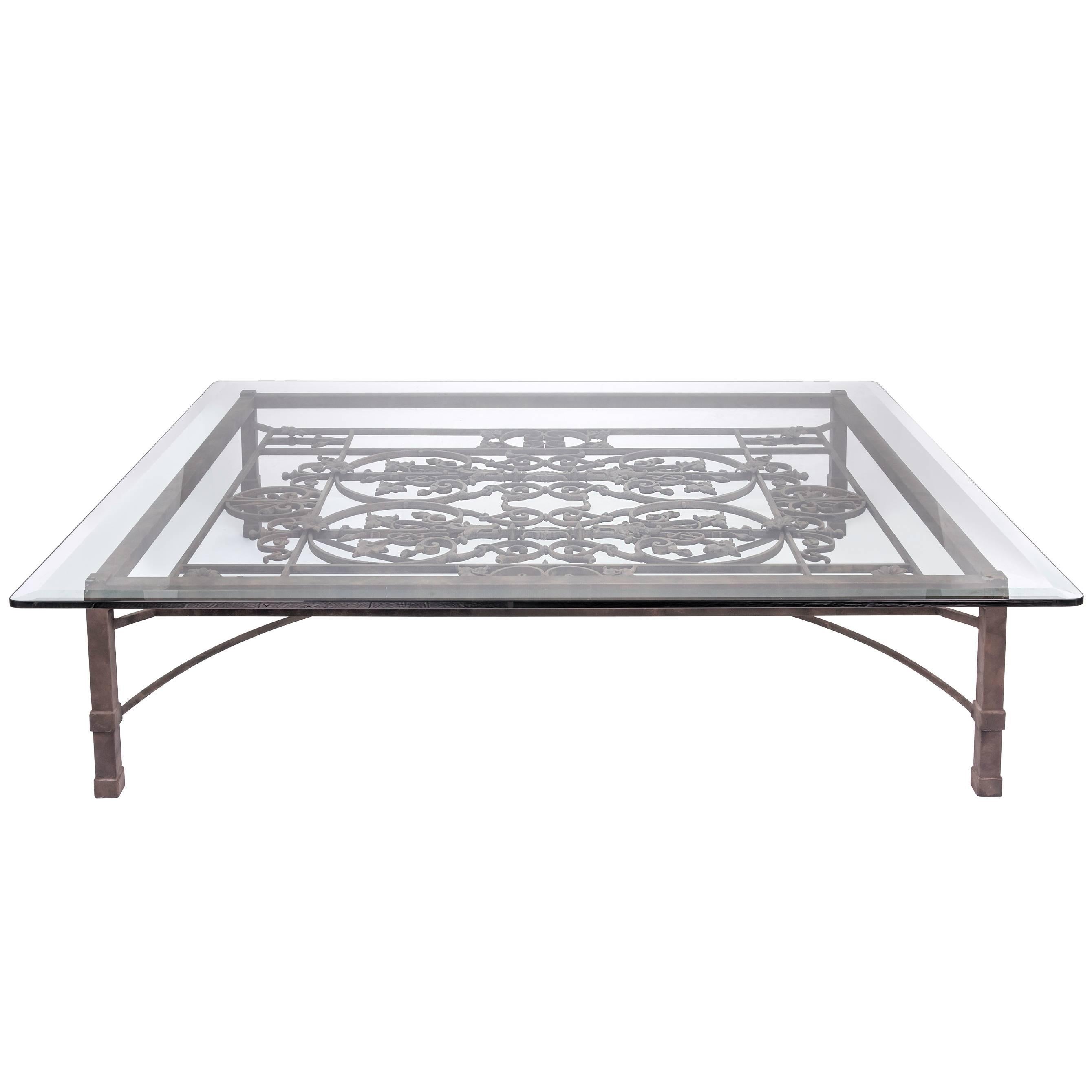 Stunningly beautiful coffee table. The base of the coffee table is made from a beautiful old 19th century iron gate from France. Large overscale size.
Measures: Iron base is 52; X 64.25
Glass is 3/4  thick.
Overall size with glass top: 60 X 72x18.25