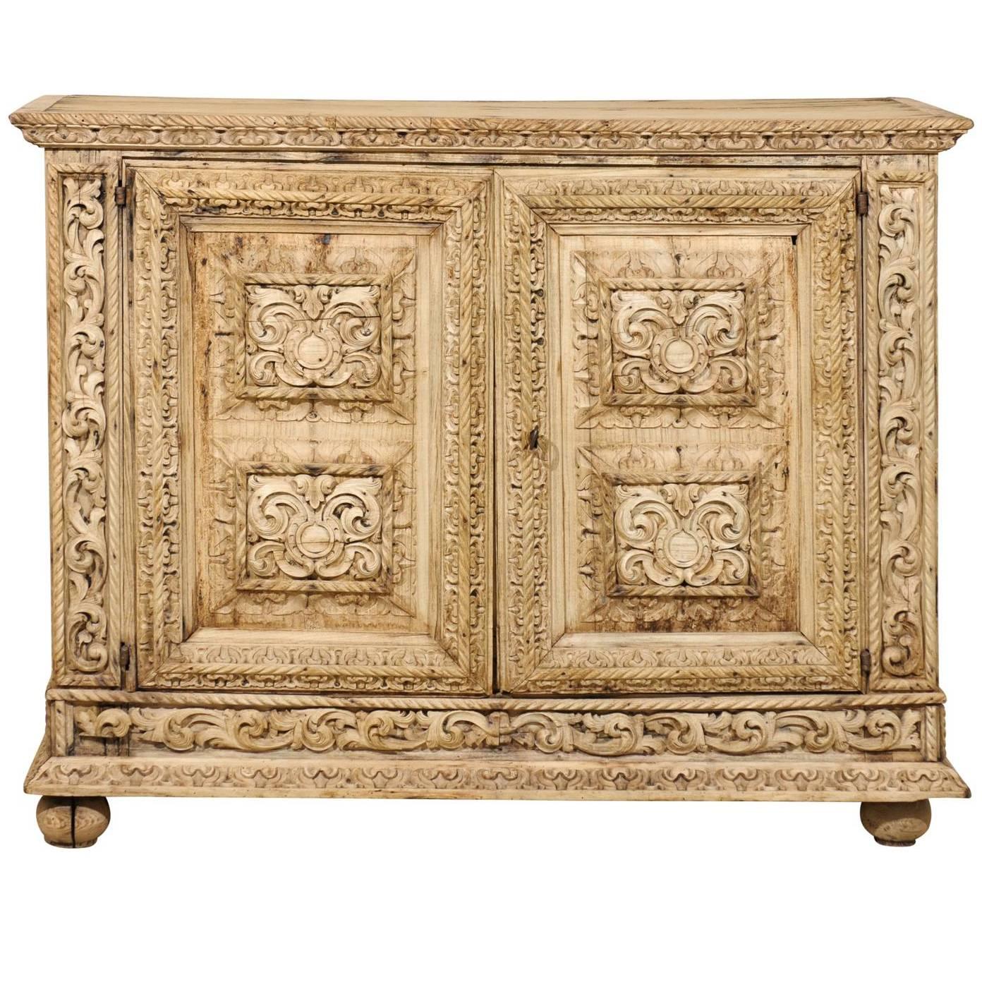 An Italian 18th Century Two-Door Bleached Wood Credenza Richly Carved with Age