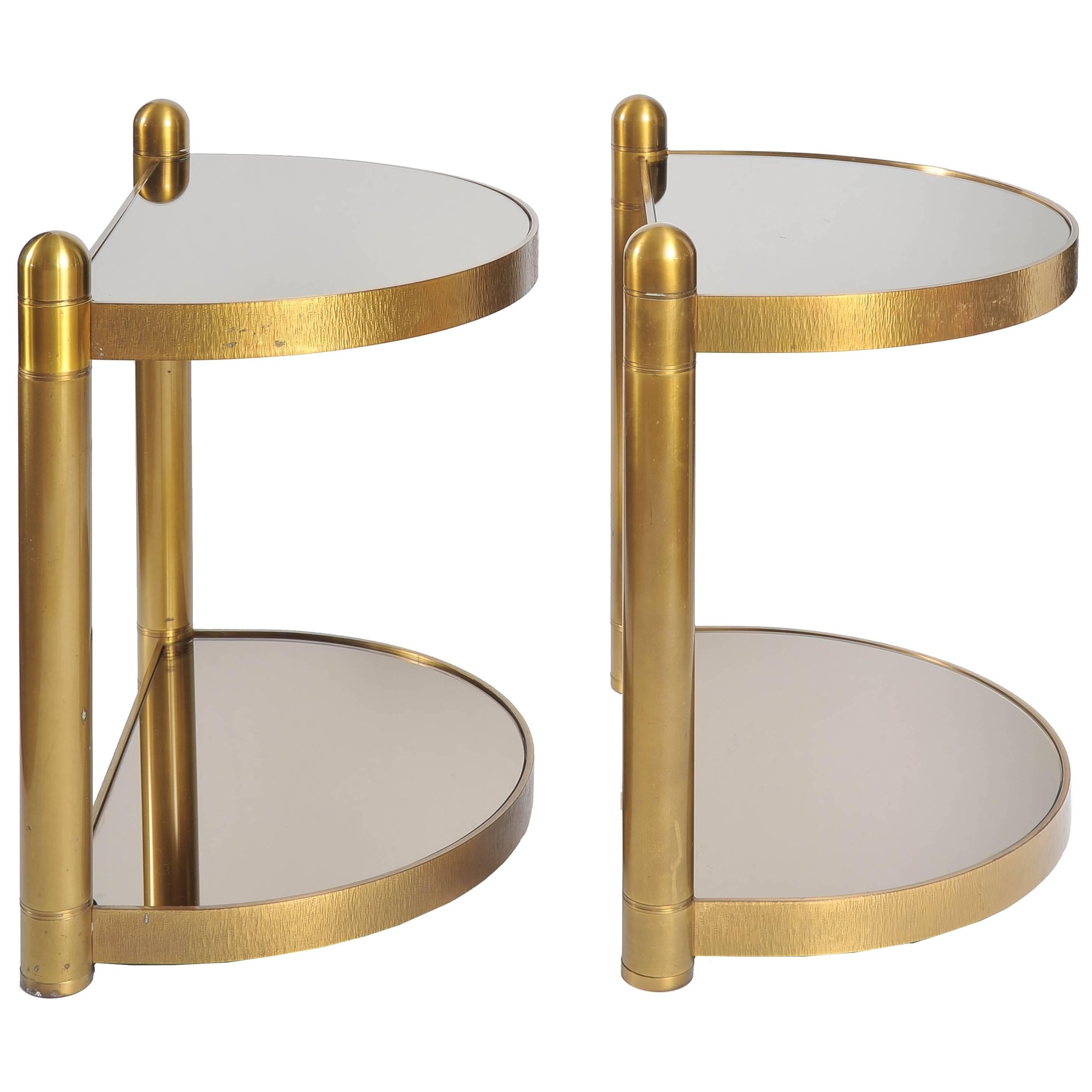 Brass framed side tables each with two 'half moon' smoked mirror shelves.