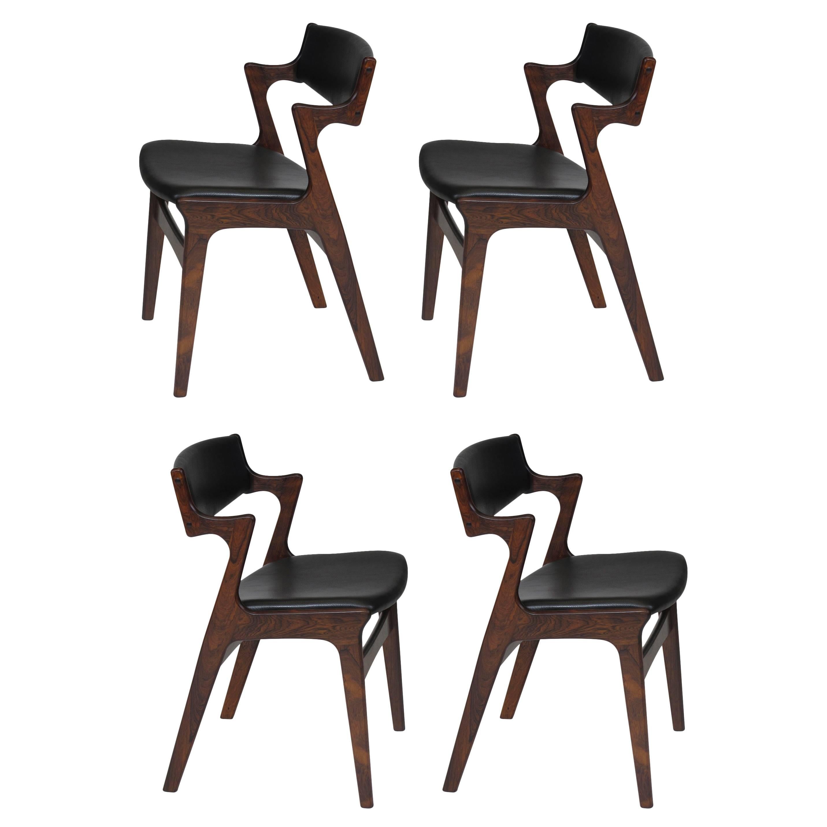 Four Danish Rosewood and Black Leather Dining Chairs