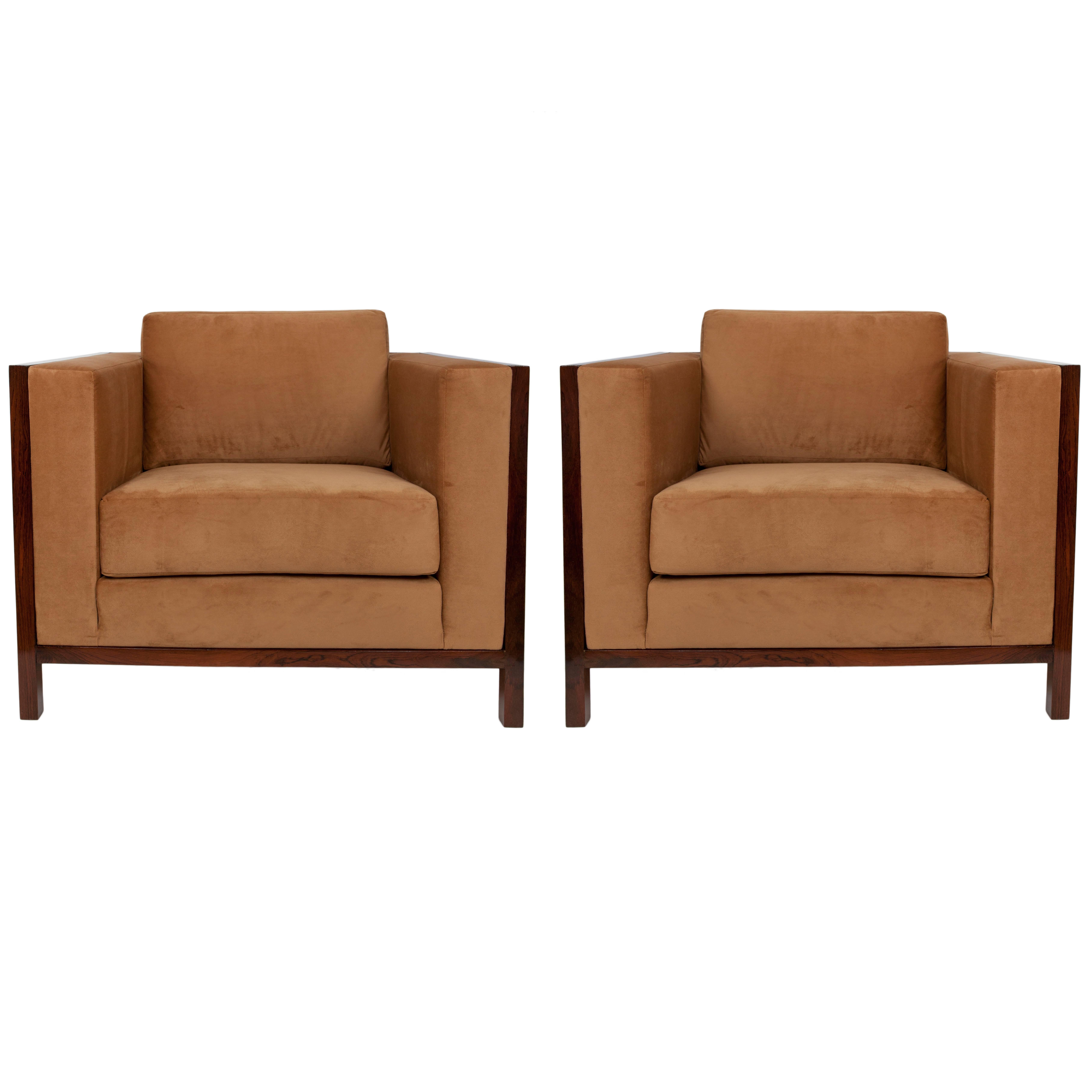 A pair of armchairs, manufactured circa 1960s, each upholstered in camel colored velvet against Brazilian jacaranda wood frames. Very good vintage condition, recently reupholstered.

10842