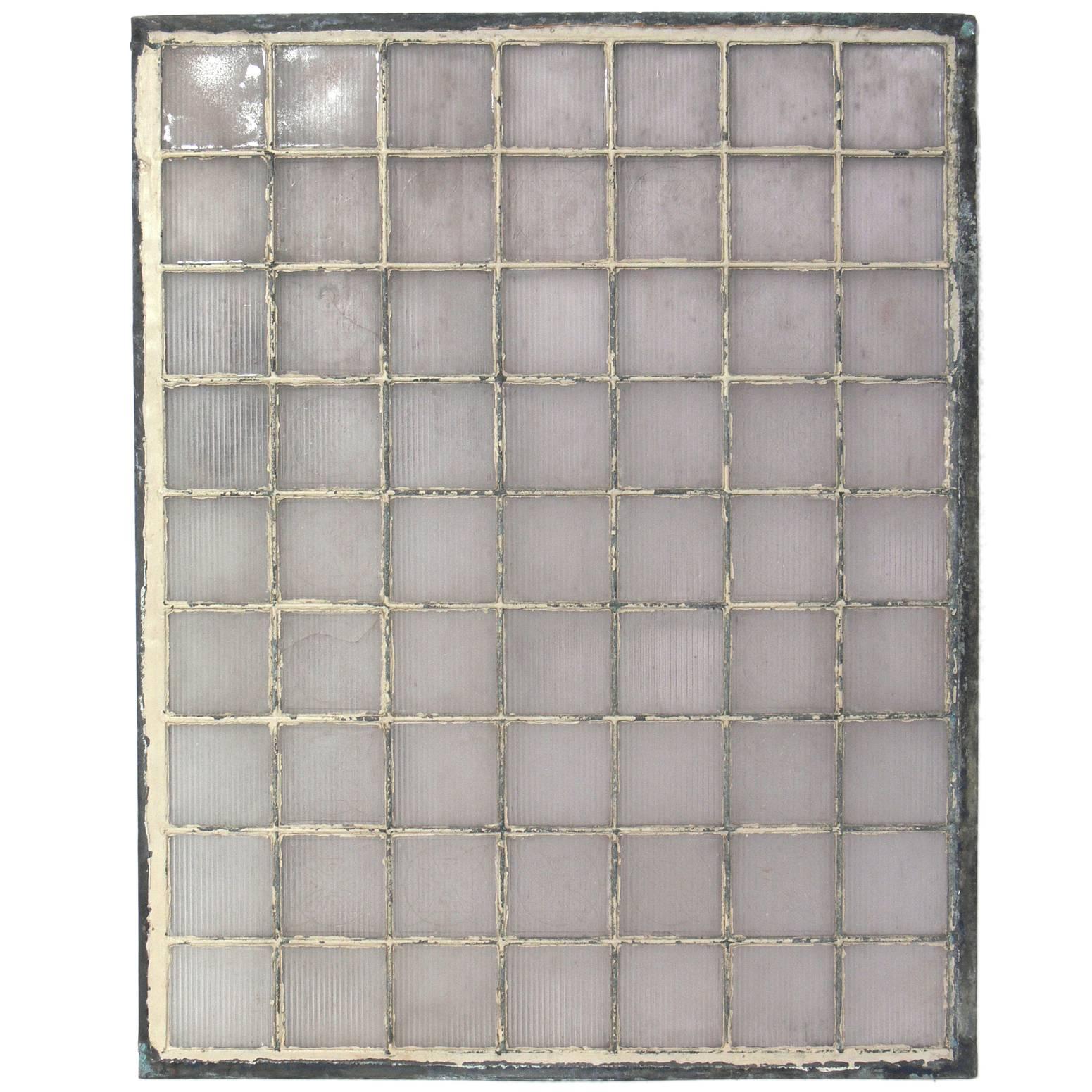 Leaded glass tile window, containing tiles designed by Frank Lloyd Wright for the Luxfer Prism Company, American, circa 1900. The pattern on the nine decorative tiles was patented by Wright for the Luxfer Prism Company in 1897.

Literature: Light