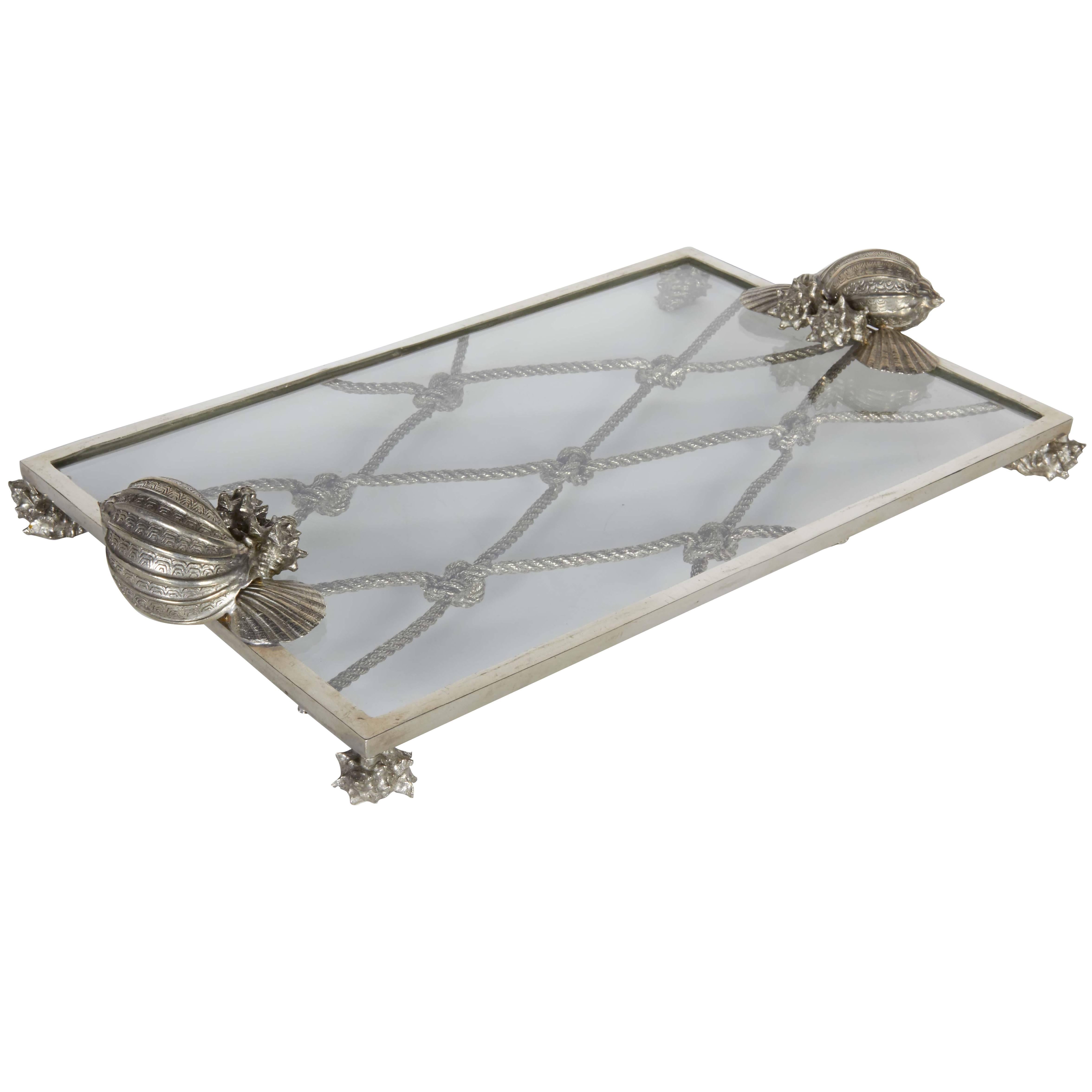 Exquisite pewter and glass serving tray with nautical theme.  All handcrafted pewter frame with glass top, featuring sea shell and knotted rope motifs.  Great addition to any barware set. 
