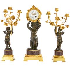Fine Porphyry, Gilt and Patinated Bronze Three-Piece Clock Set by H. Dasson