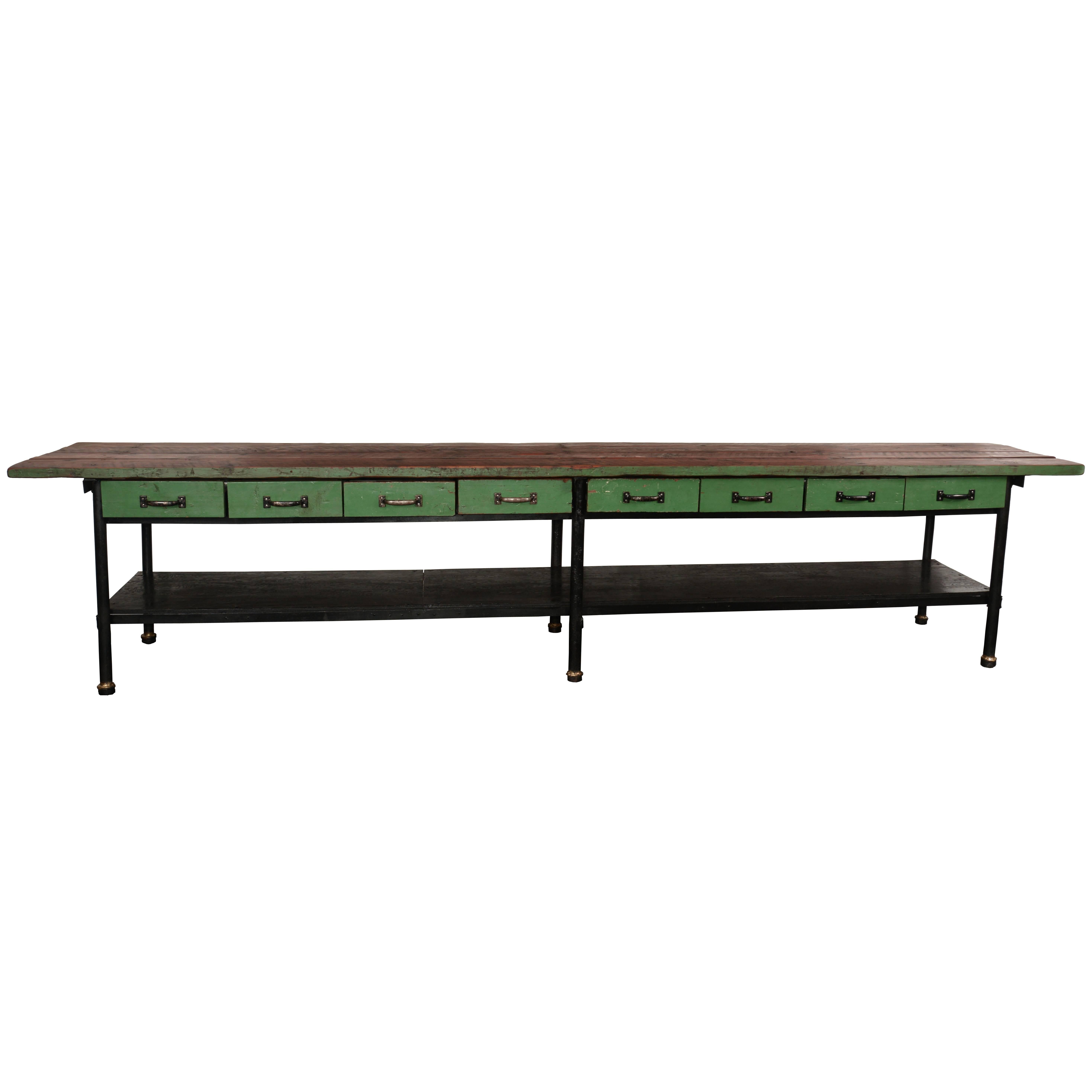 Long green work table. This 14 beauty came out of a machine shop in Northern California. There are eight generous drawers with their original hardware. The frame is steel with Douglas fir plank top and a black painted plywood lower shelf. The back