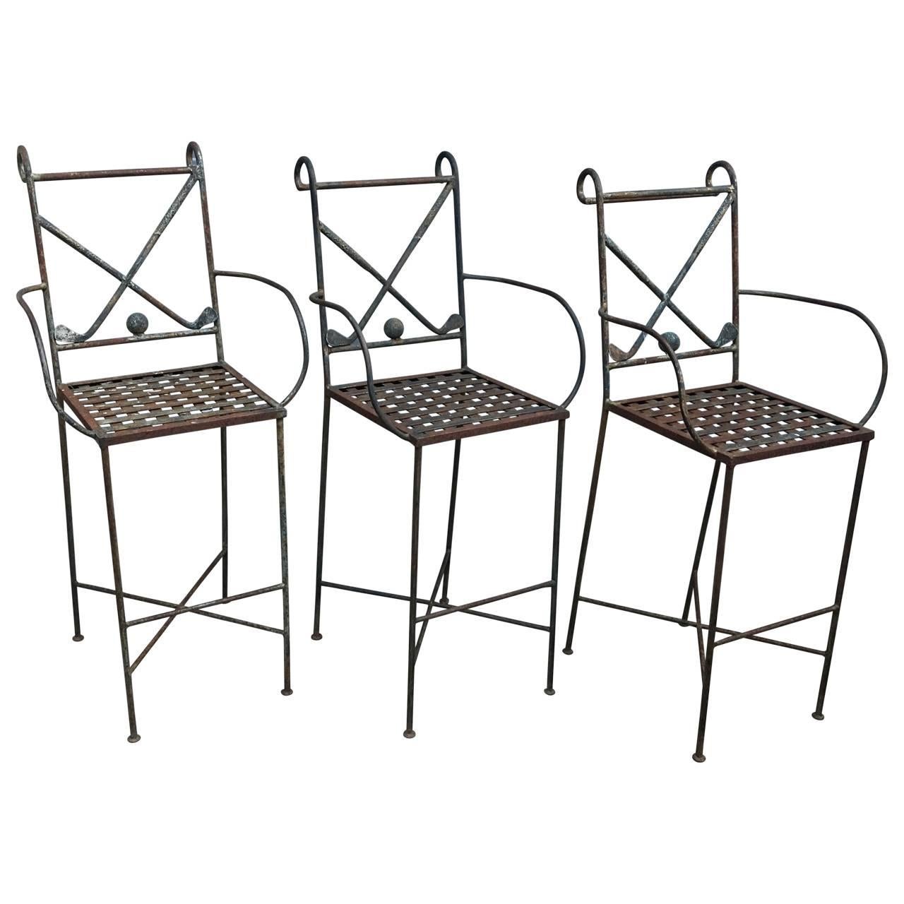 Three solid iron bar armchairs with two golf clubs and a golf ball incorporated in the back seat. The stools has pillows in all-weather fabric and are made in the manner of designer Ilana Goor.
Seat height 29 inches.
Table height 38 inches.