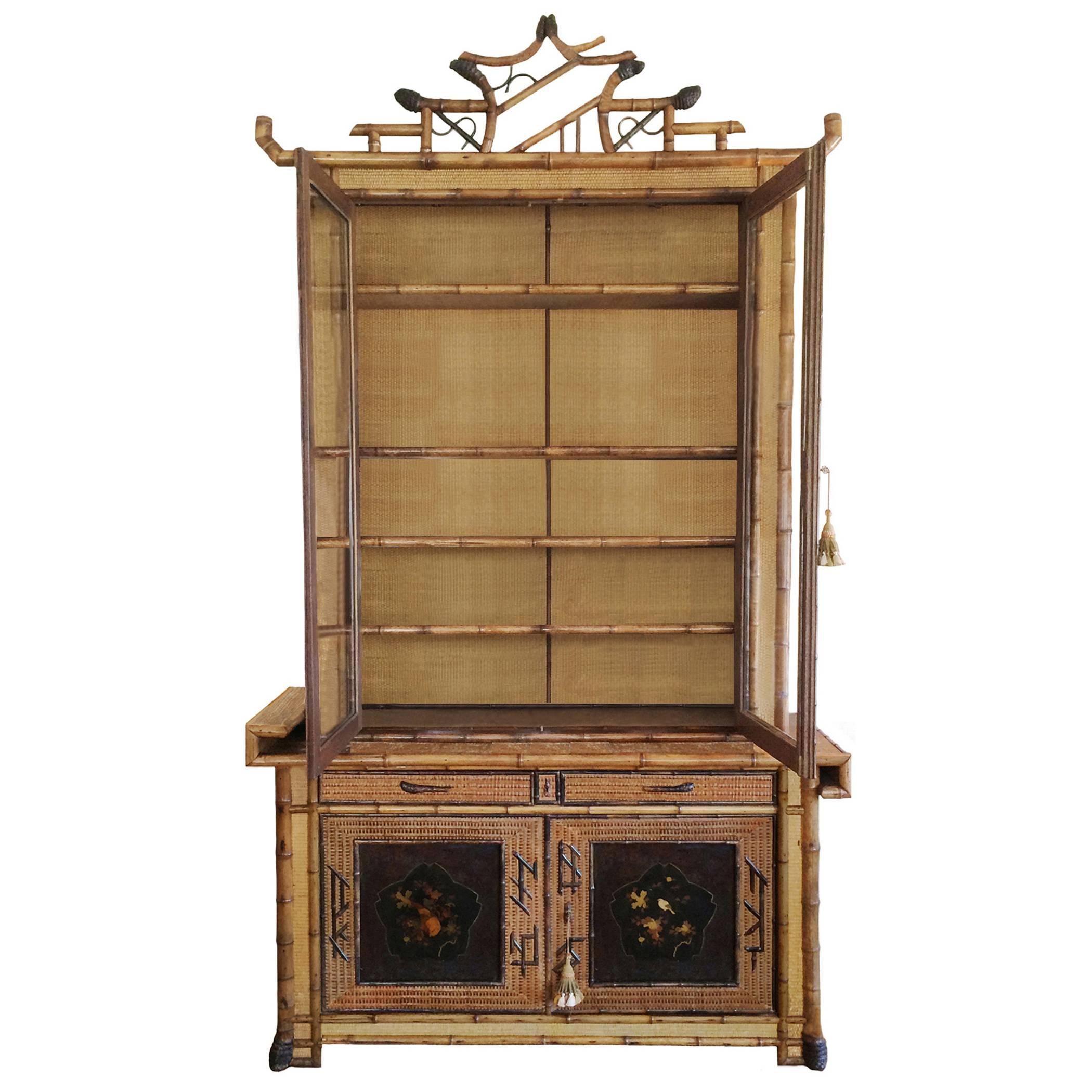 Unique French fantasy Japonais bamboo cabinet by Perret et Vibert. Woven straw, rattan, bamboo applique, japanned lacquer panels; intricate fretwork, make this two-piece cabinet unique and very rare, circa 1880.


 