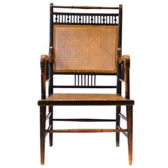 E W Godwin. An Anglo-Japanese Ebonized Beech and Caned Armchair