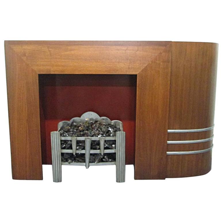 For Sale on 1stdibs - Spectacular Art Deco fireplace and mantel. Well made. The fireplace and mantel has one curved side with metal detail toward the bottom. The grill shown