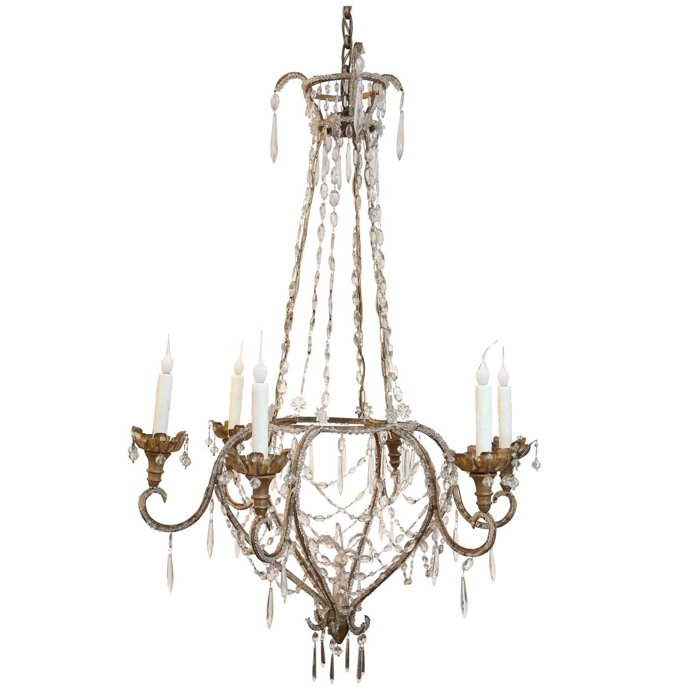 Beaded and gilt iron Italian chandelier from Genoa (early 19th century), in original finish and featuring a connecting basket/cage round structure and upper tier, fully beaded with original and antique glass beads and decorated with crystal