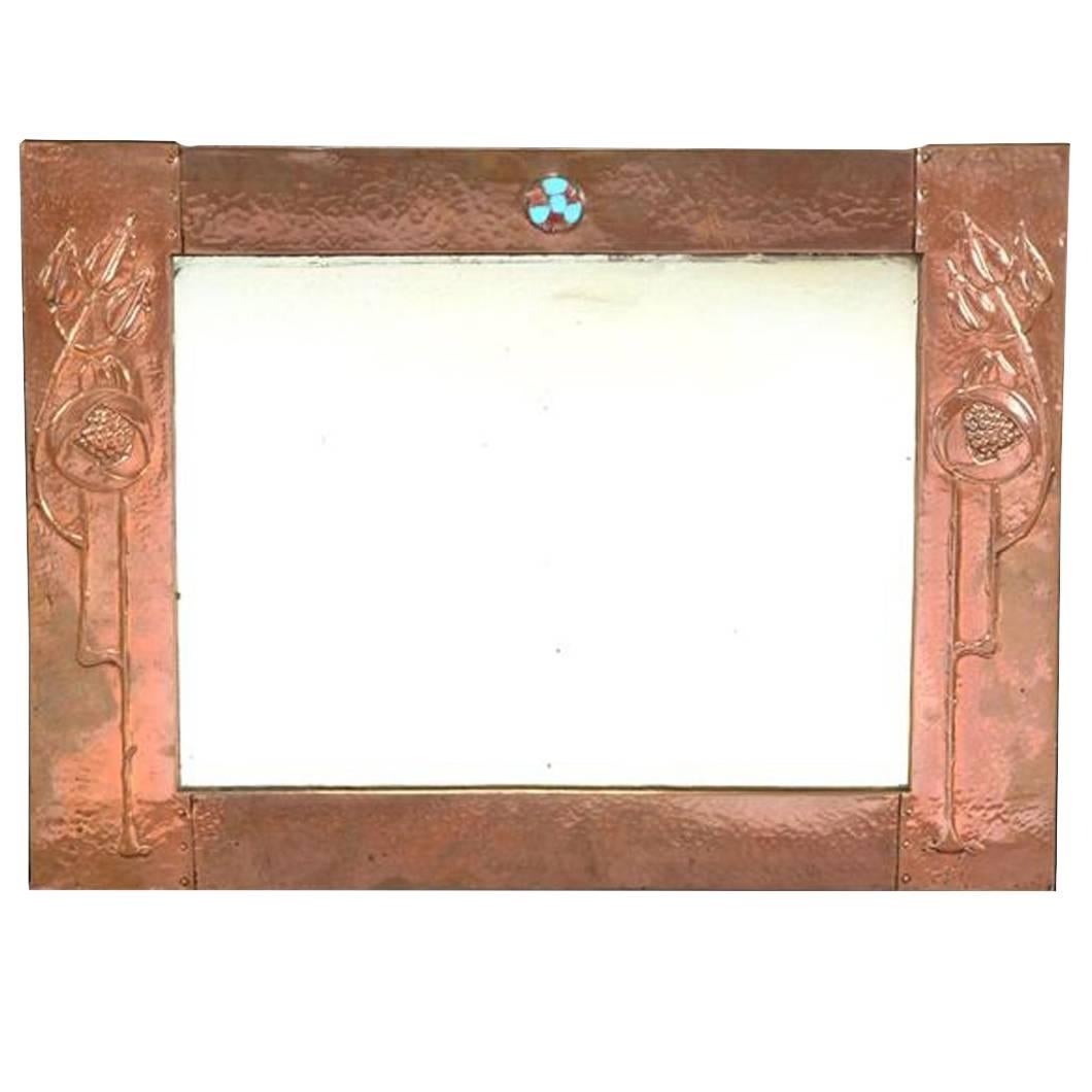 Glasgow School, An Arts & Crafts Hammered Copper Wall Mirror with pomegranates