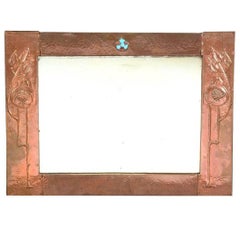 Glasgow School, An Arts & Crafts Hammered Copper Wall Mirror with pomegranates