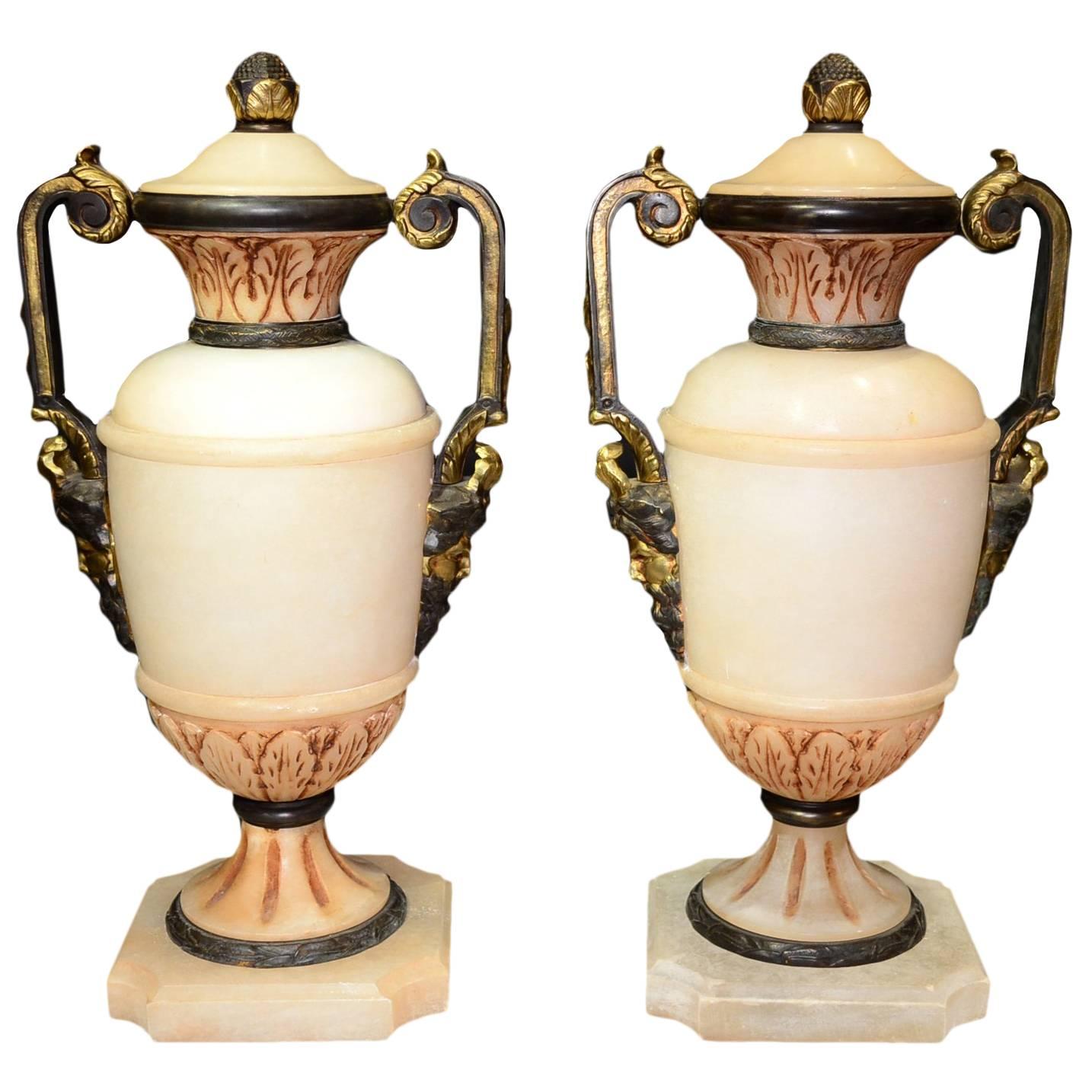 Neoclassical Pair of Carved Alabaster and Bronze Urns with Mask Face Handles