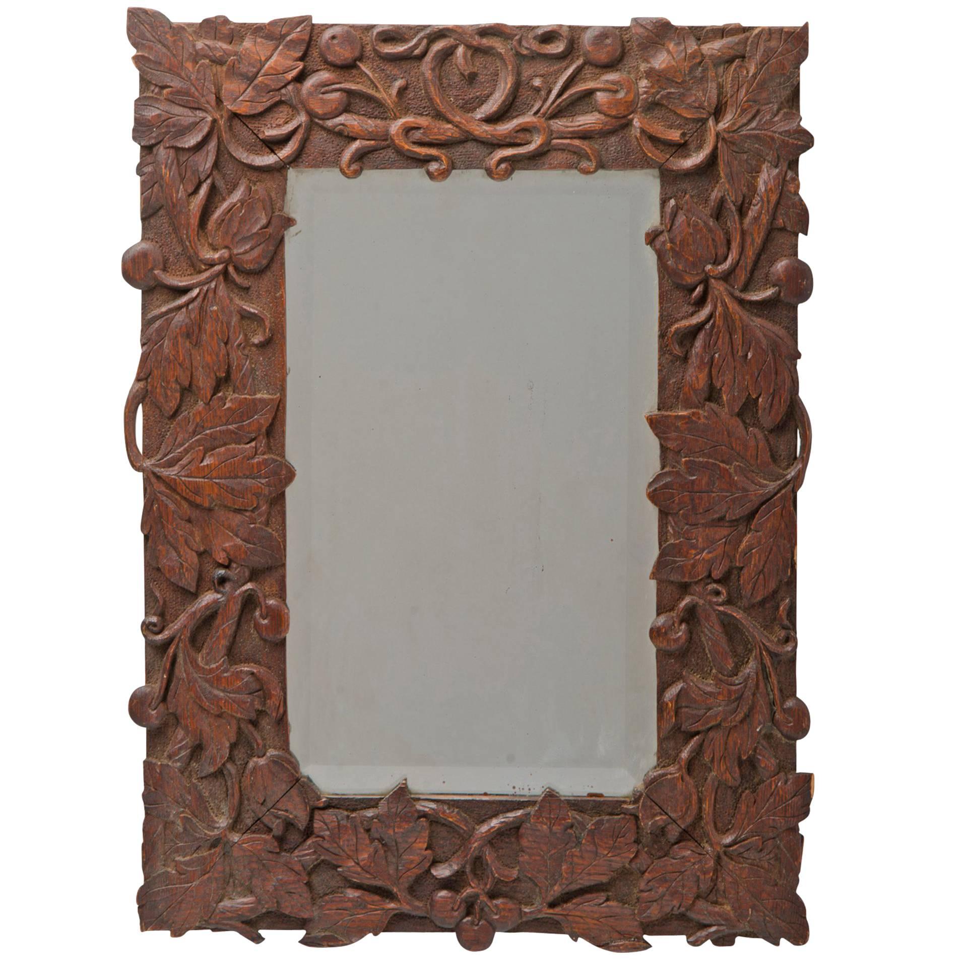 Beveled Mirror with Ornately Carved Frame, circa 1910s