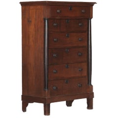 A Tall Chest of Drawers with Ebonized Side Columns and Knobs
