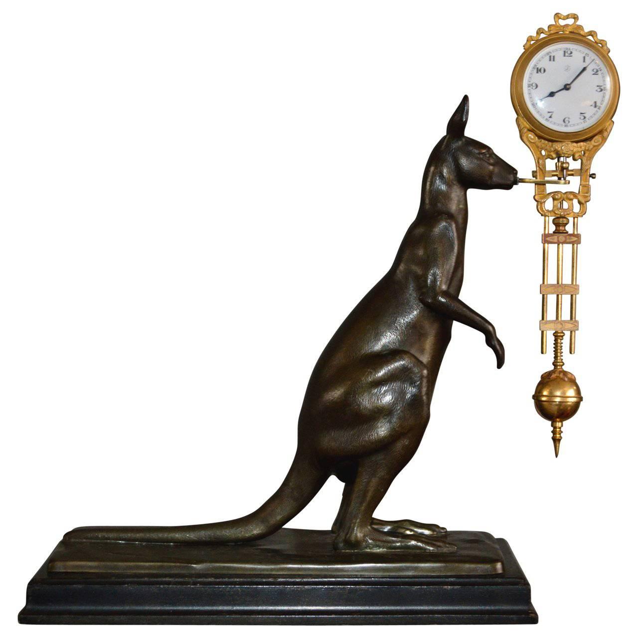 Kangaroo spelter clock by Junghans, with eight-day movement, enamel deal with Arabic numerals, blue-steel hands. The kangaroo stands on a black-stained wooden base.