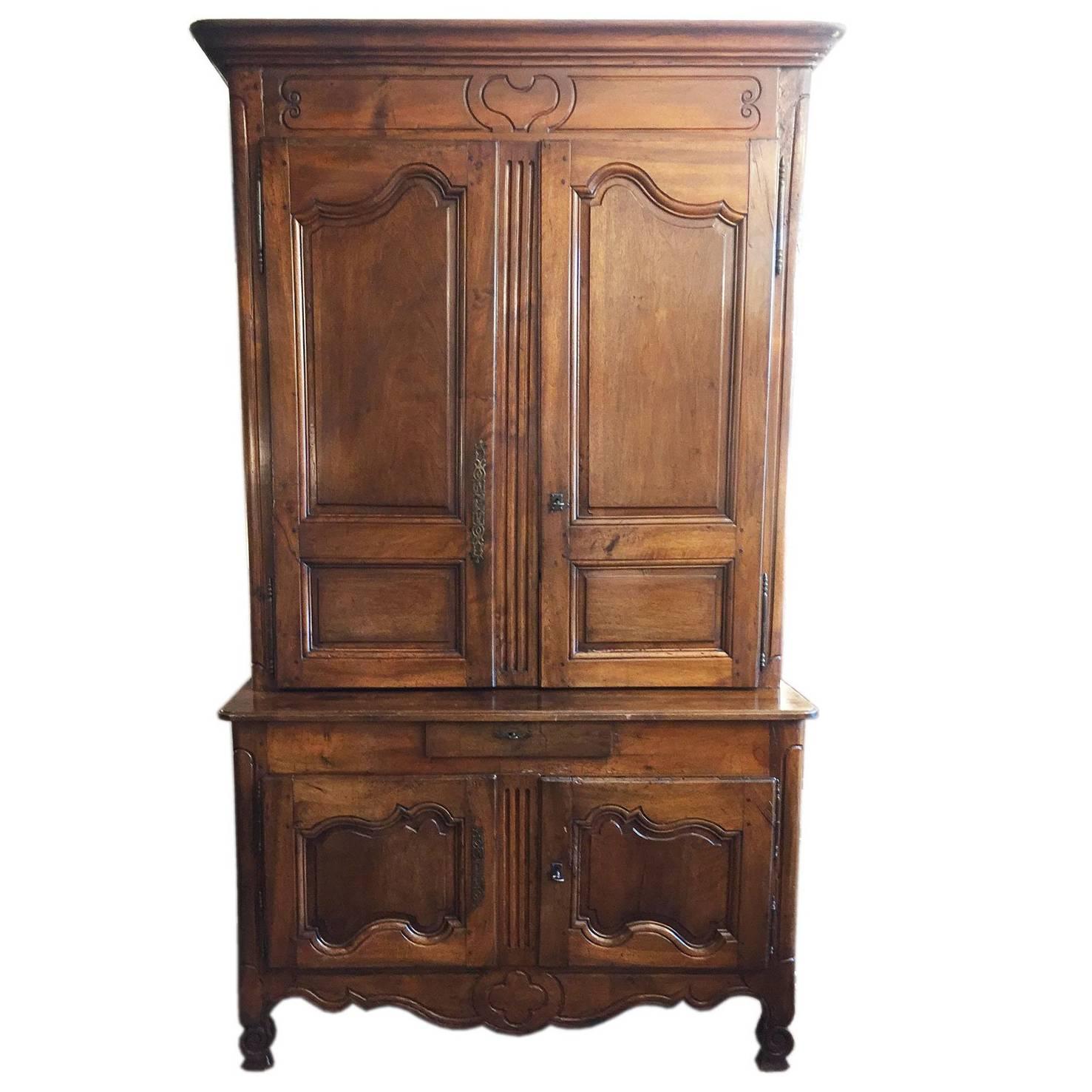 Late 18th century French walnut two-tiered cabinet,   with the top cabinet being shallowing than the bottom cabinet, an antique hand-carved two-door buffet from  Provence, total height 101.19 inches, 257 centimeters. 
Large Louis XV chestnut buffet