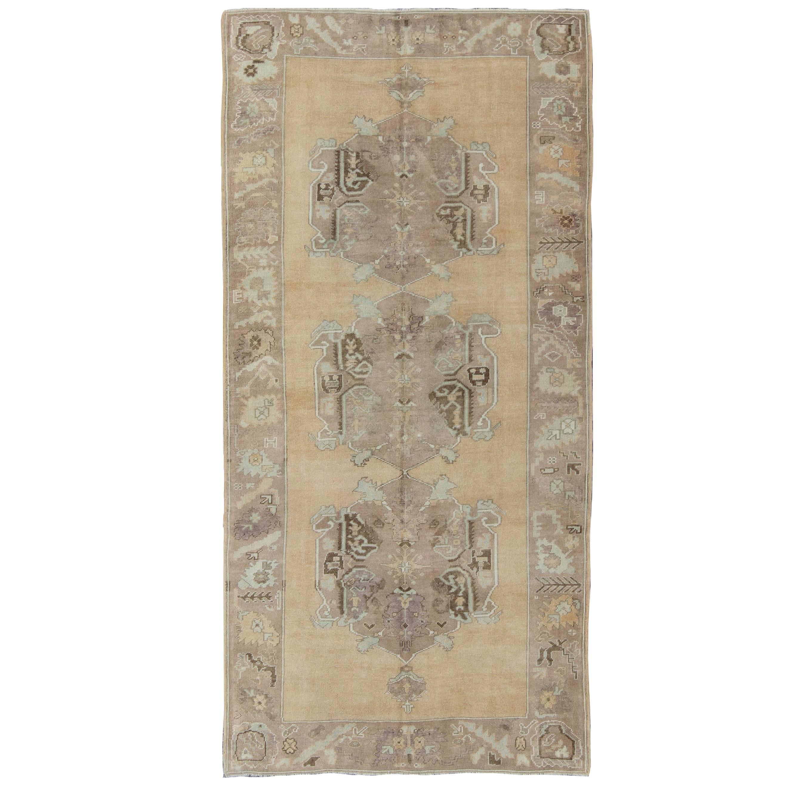 Vintage Oushak Rug with Three Central Medallions Set on Faint Sand-Colored Field For Sale