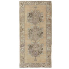 Vintage Oushak Rug with Three Central Medallions Set on Faint Sand-Colored Field