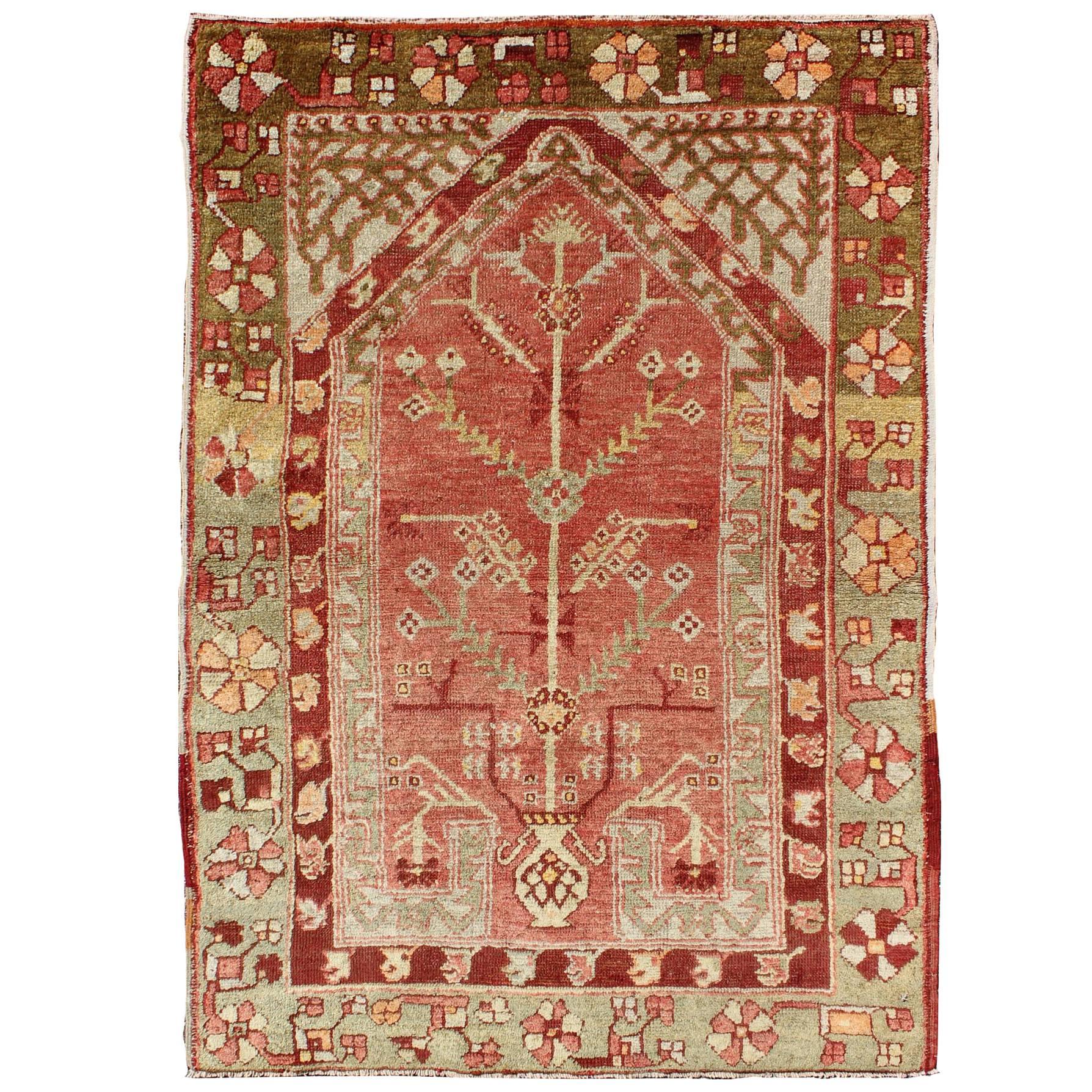 Antique Oushak Rug with Directional Tribal Motifs in Soft Pink Red & Green For Sale