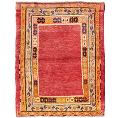 Turkish Oushak Rug with Open Red Field and Colorful Floral Borders