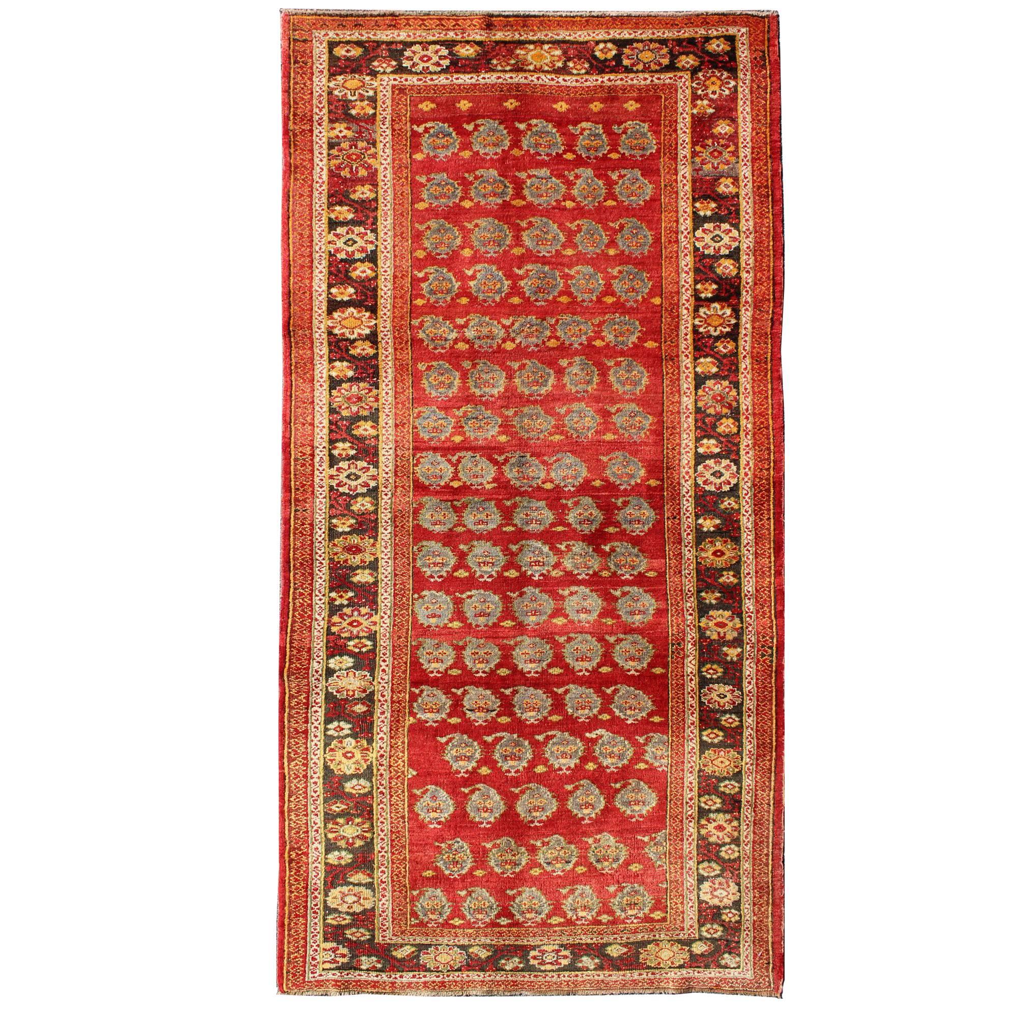 Vintage Turkish Oushak Carpet with All-Over Paisley Design and Central Red Field