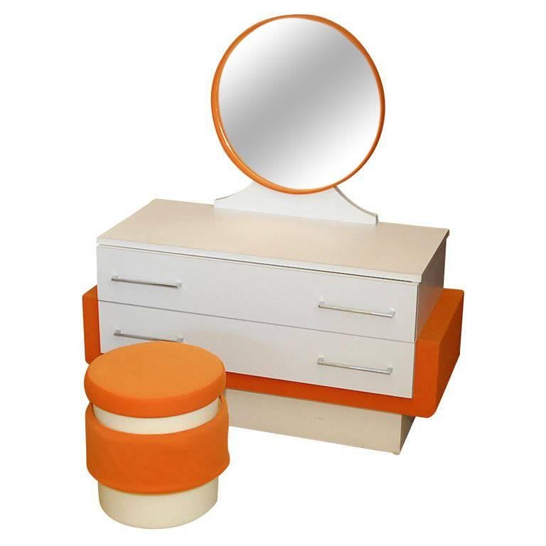 This vanity is made of white formica and orange fabric.