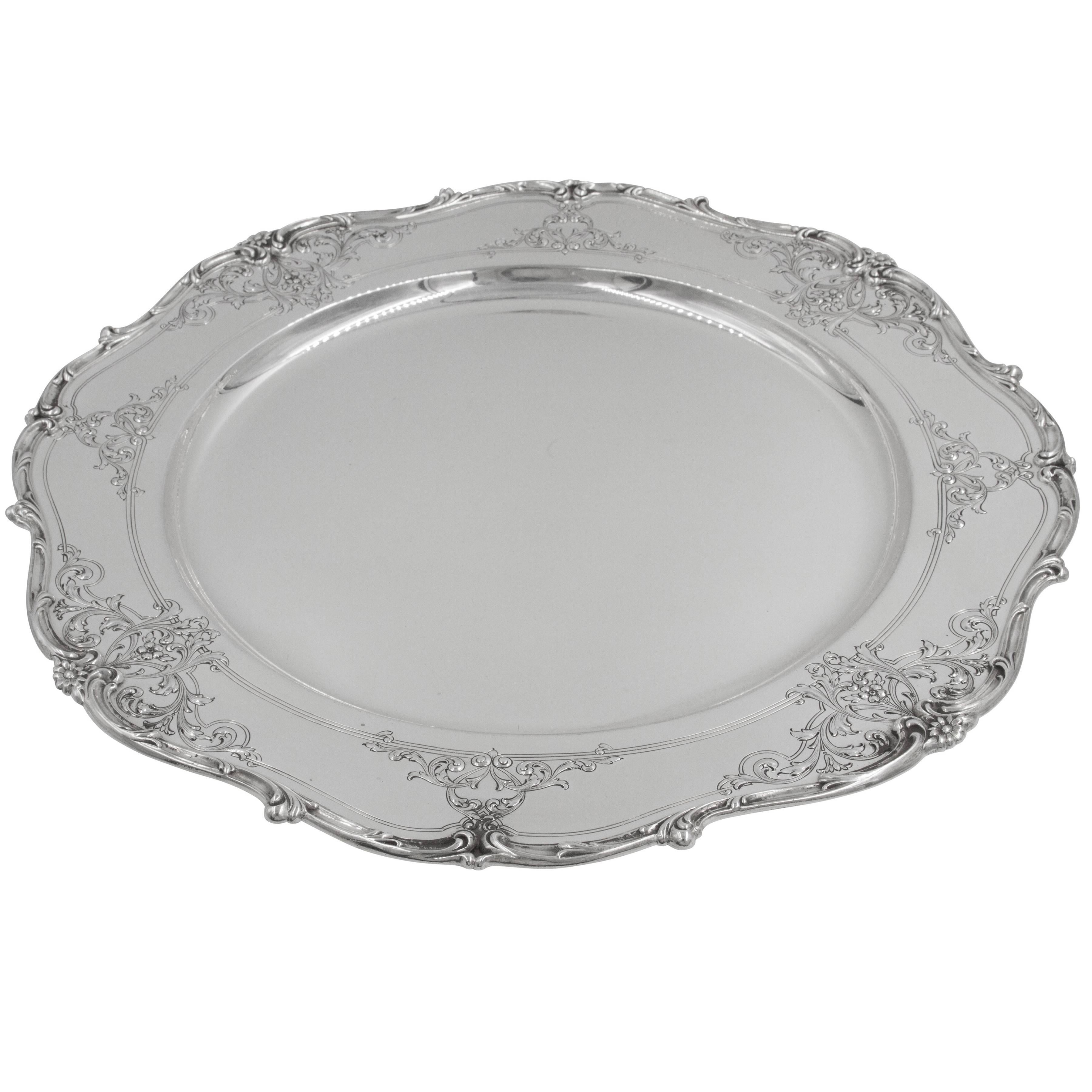 Before we describe this piece, let's take a moment to wish it a happy birthday it's now 101 years old! (And looking darn good too!) Delicate etching of flowers and vines grace the rim of this scalloped platter giving it a softer and old-world feel.