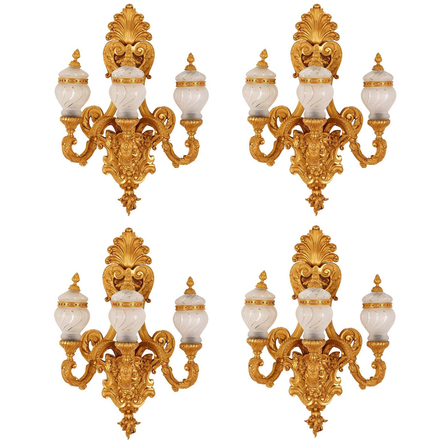 Set of Four French Gilt Bronze ‘Ormolu’Mounted Glass Three-Light Wall Lights For Sale