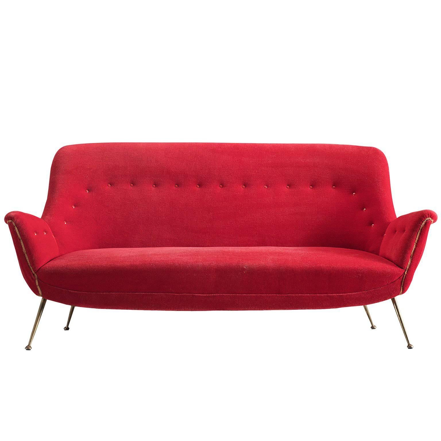 Nice Venetian red Italian lounge set original from the 1950s. 

This set is an iconic example of Italian design from the fifties. Organic and sculptural, this two-and-a-half-seat sofa and two matching lounge chairs are anything but minimalistic.