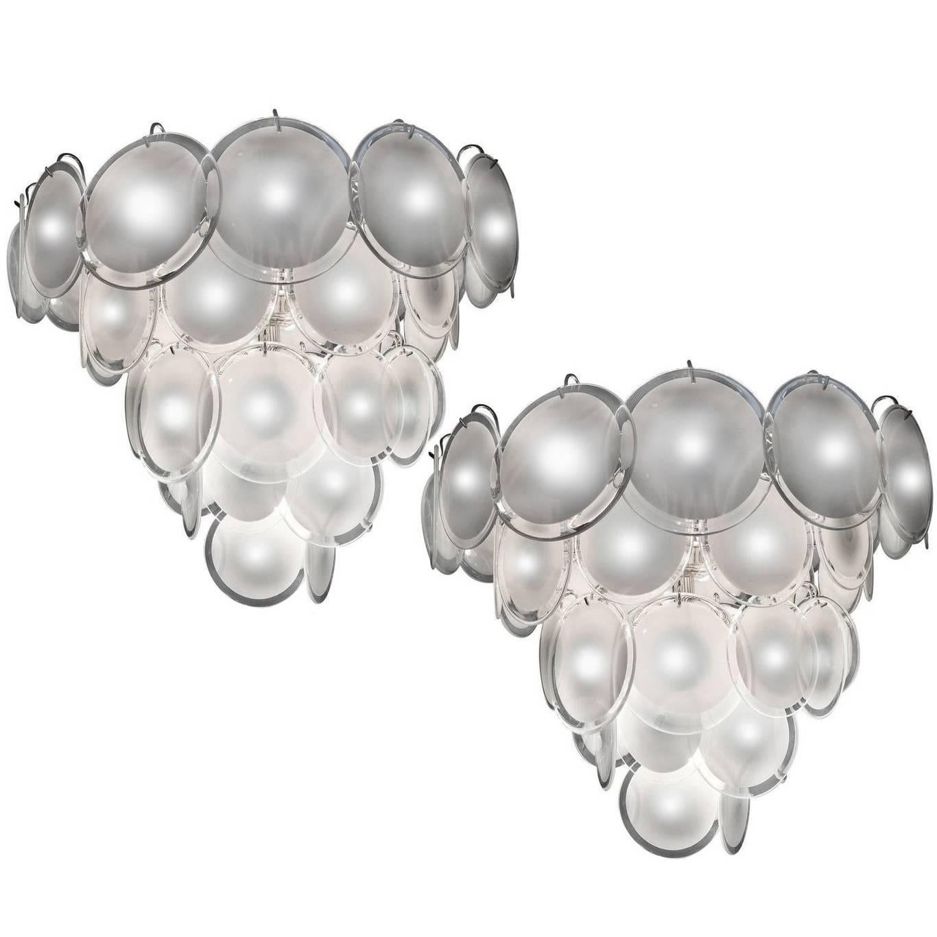 Spectacular pair of chandeliers by Vistosi made of 50 Murano discs white put on five floors. Six available items with matching wall sconces.