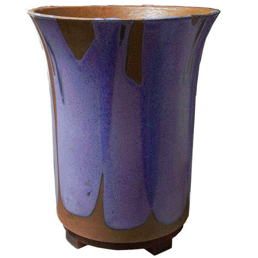 Set of two remarkably beautiful and unique planters show off sculptor David Cressey's talent for swirling glaze to create flame like motion combined with his eye for choosing stylish complimentary colors. Pair of purple flame glaze and speckled