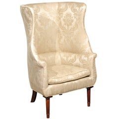 1920s Large Barrel Back Upholstered Wing Chair Raised on Four Reeded Legs