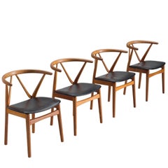 Set of Four Henning Kjaernulf Dining Chairs in Teak and Black Upholstery