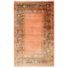 Antique Angora Wool Oushak Rug with Solid Salmon Field and Floral Borders