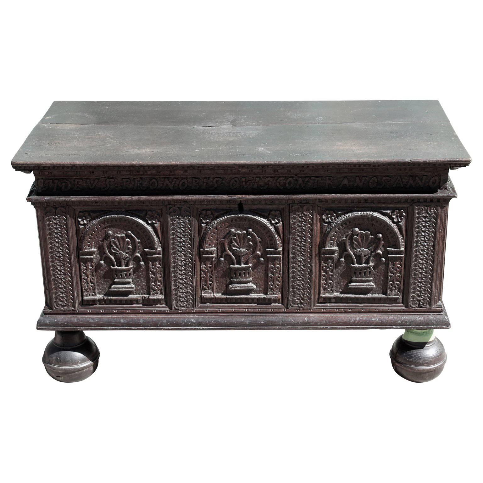 Unique oak colonial chest with bun feet and Latin engravings all the way around. Designed with groove construction. 17th century, Europe.
