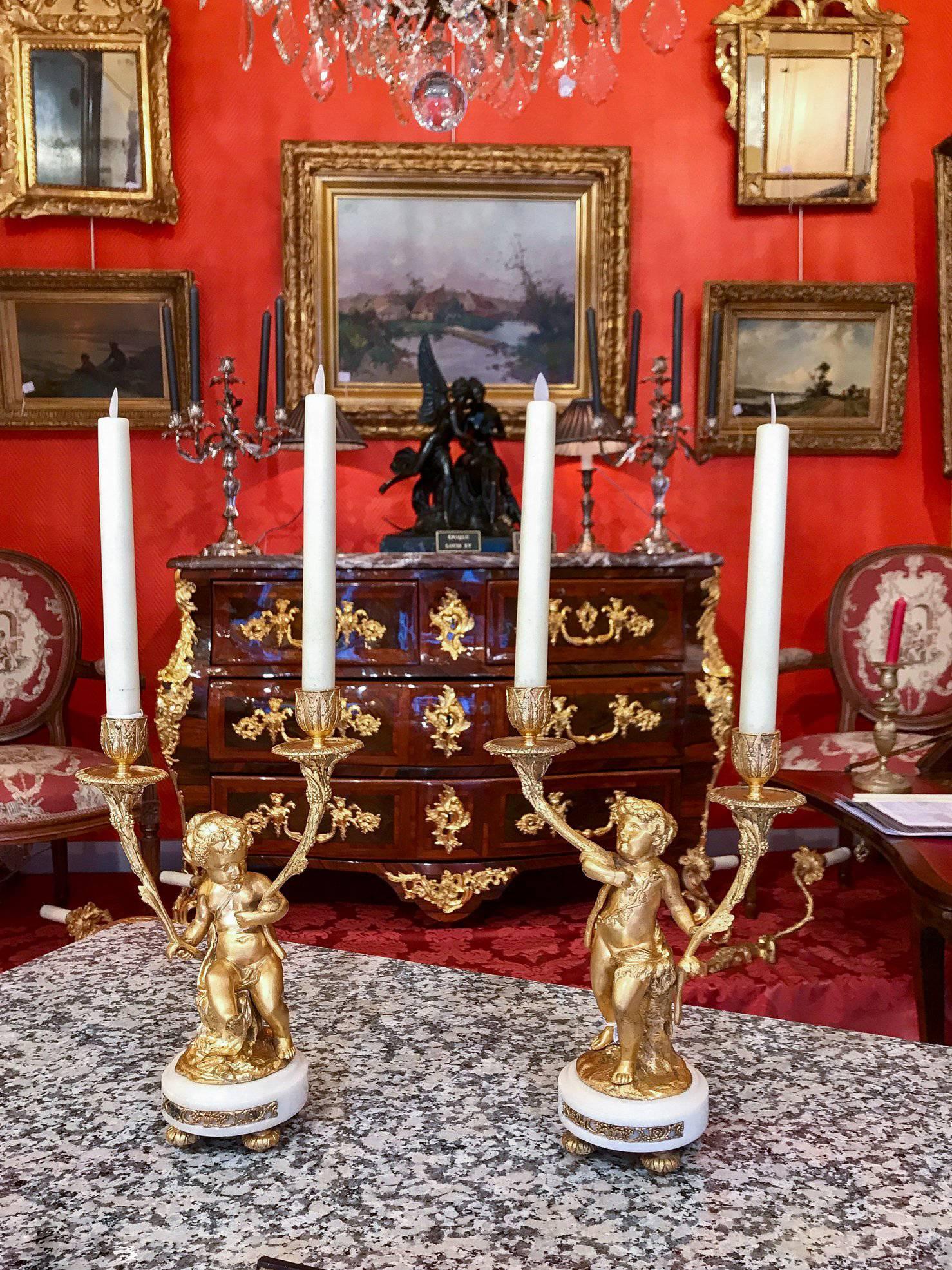 REDUCED PRICE FOR A WEEK, UNTIL FEBRUARY 17th

We are pleased to present you, a charming pair of candelabras are formed as cherubs or Putti holding the candelabra branches. Our candelabras raised on white Carrara Marble bases.

The quality of the
